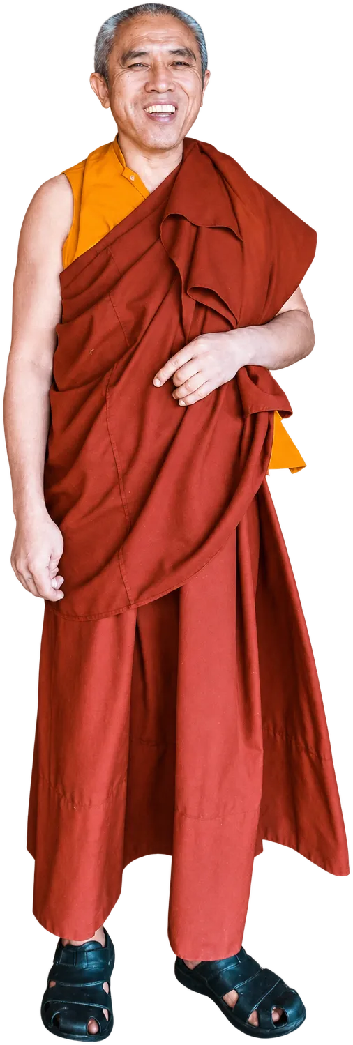 A smiling monk in a maroon robe and saffron vest, Bhutan
