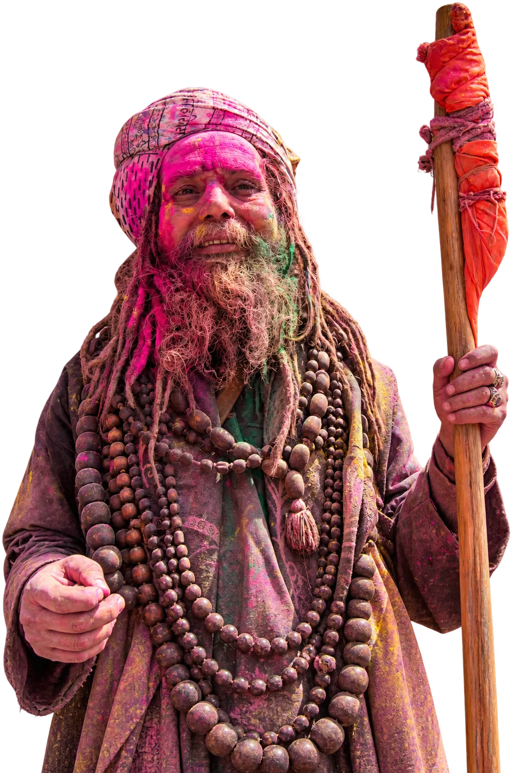 A sadhu covered in pink gulal, beads at his neck