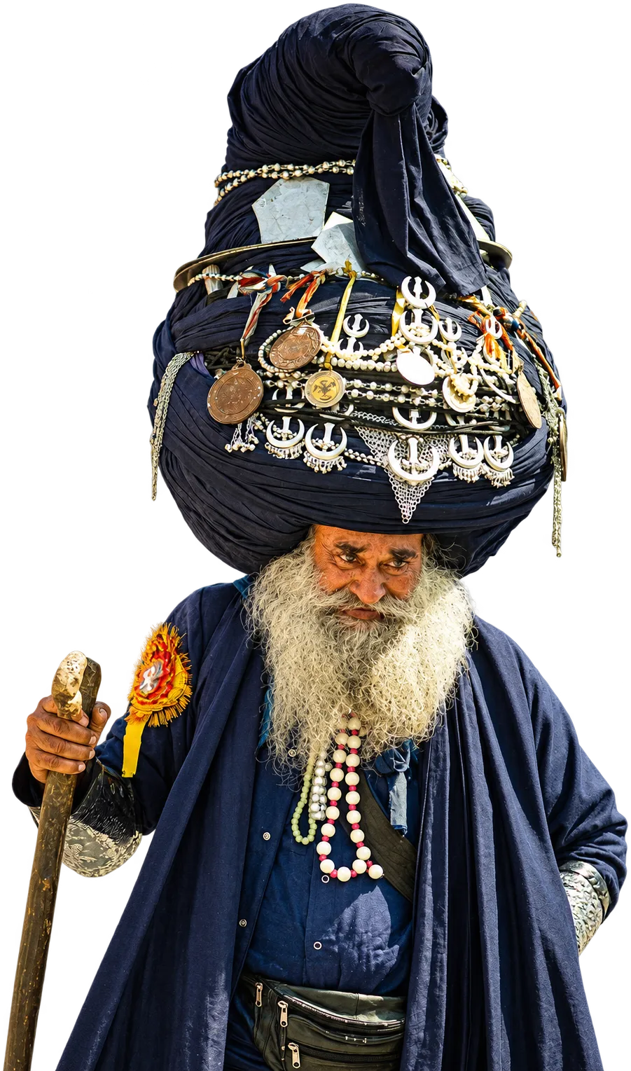 A Nihang elder with a long white beard in a tall blue dumalla turban hung with silver emblems