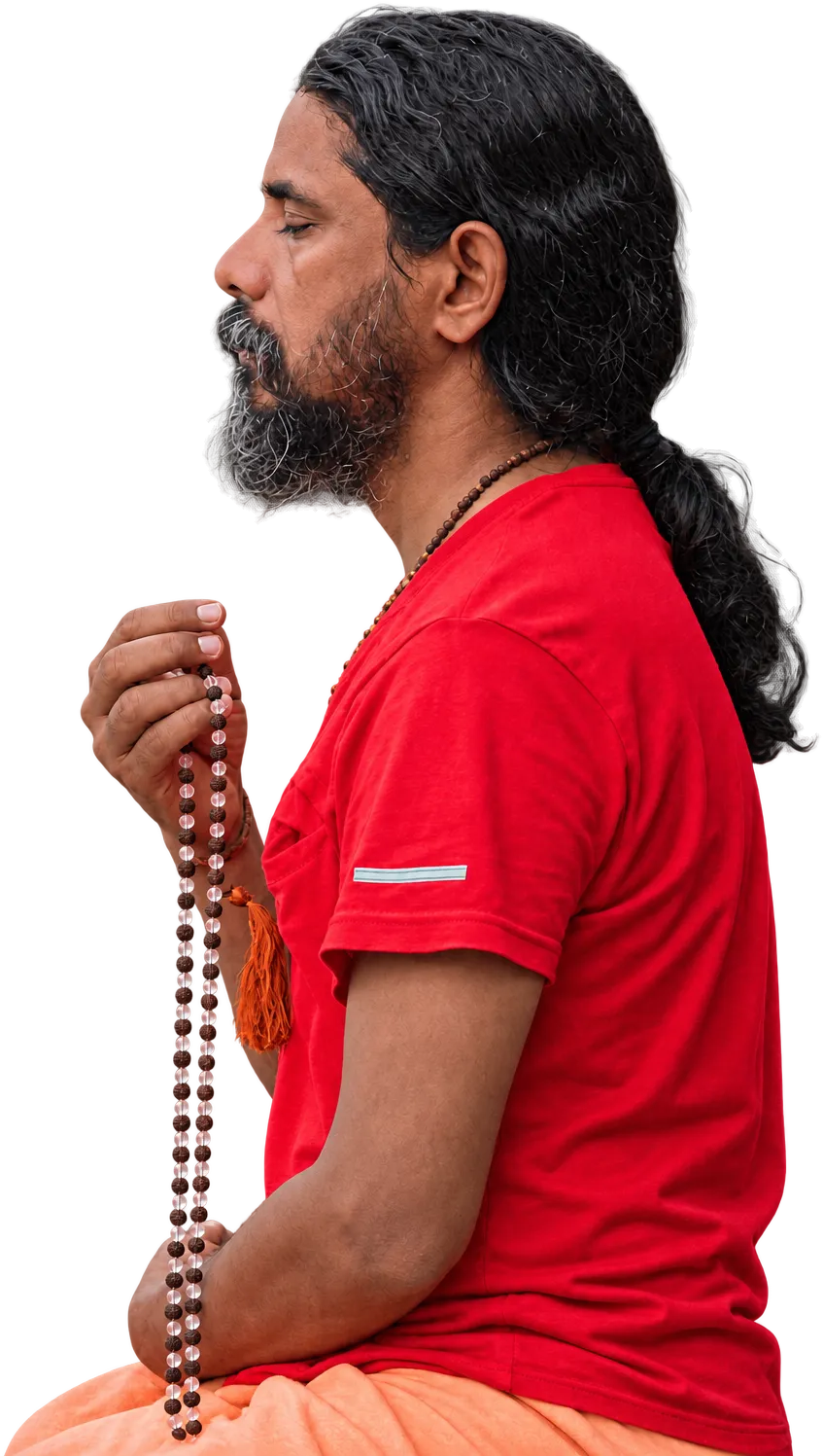 A man meditating with a mala, eyes closed, by the Ganga at Rishikesh