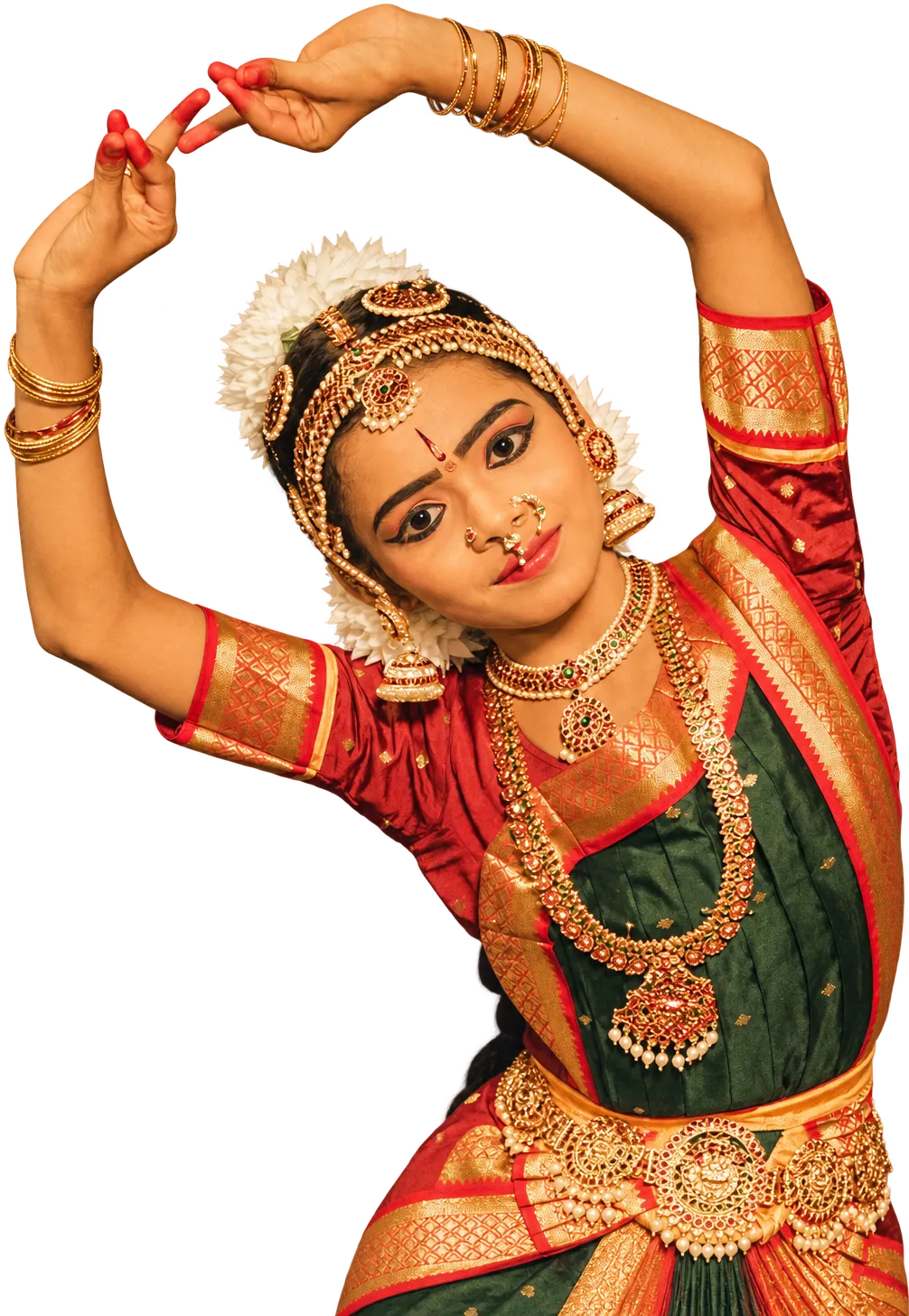 A young classical dancer in temple jewellery, arms raised