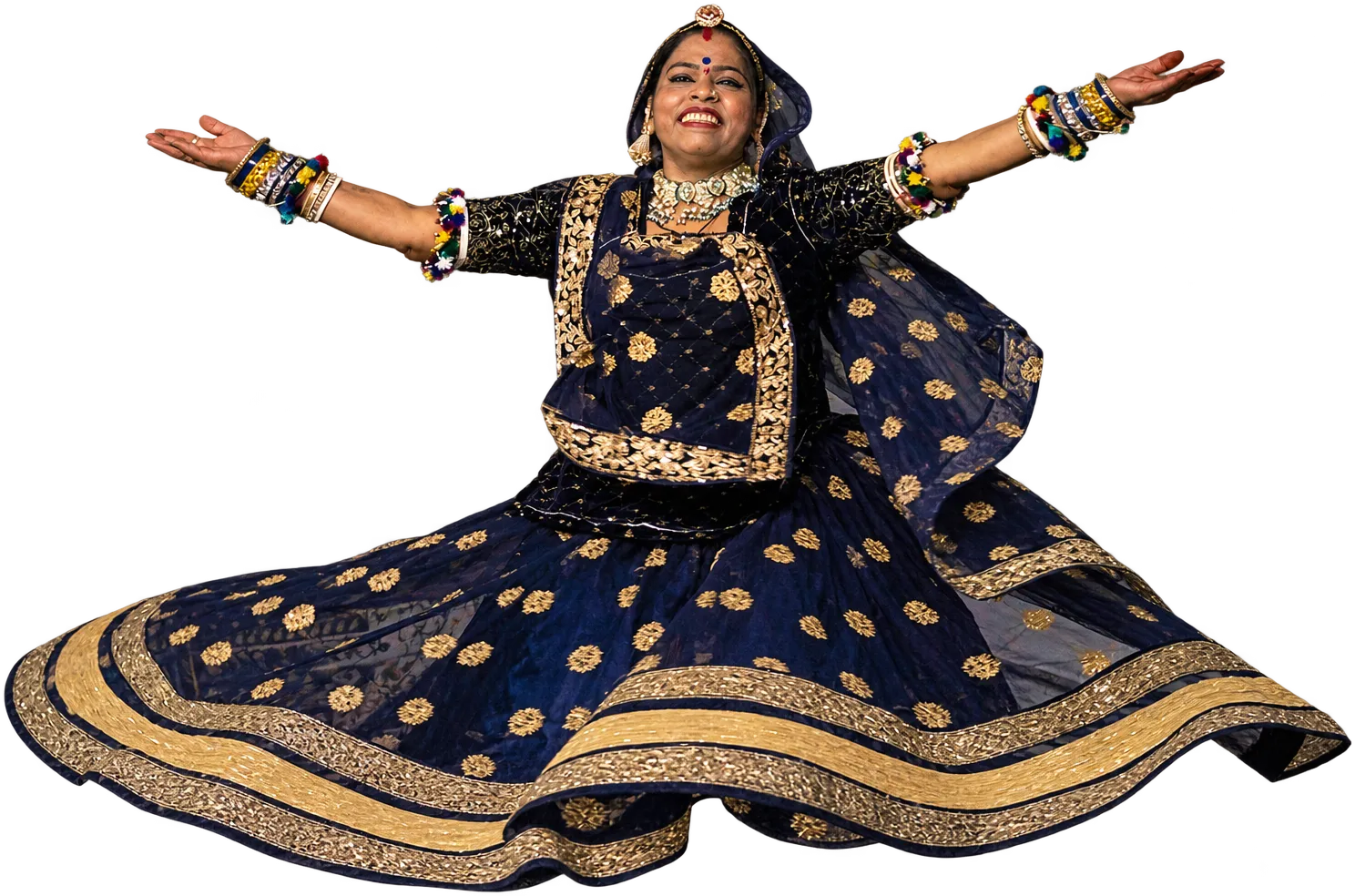 A Kalbelia dancer, arms spread wide, her skirt flared