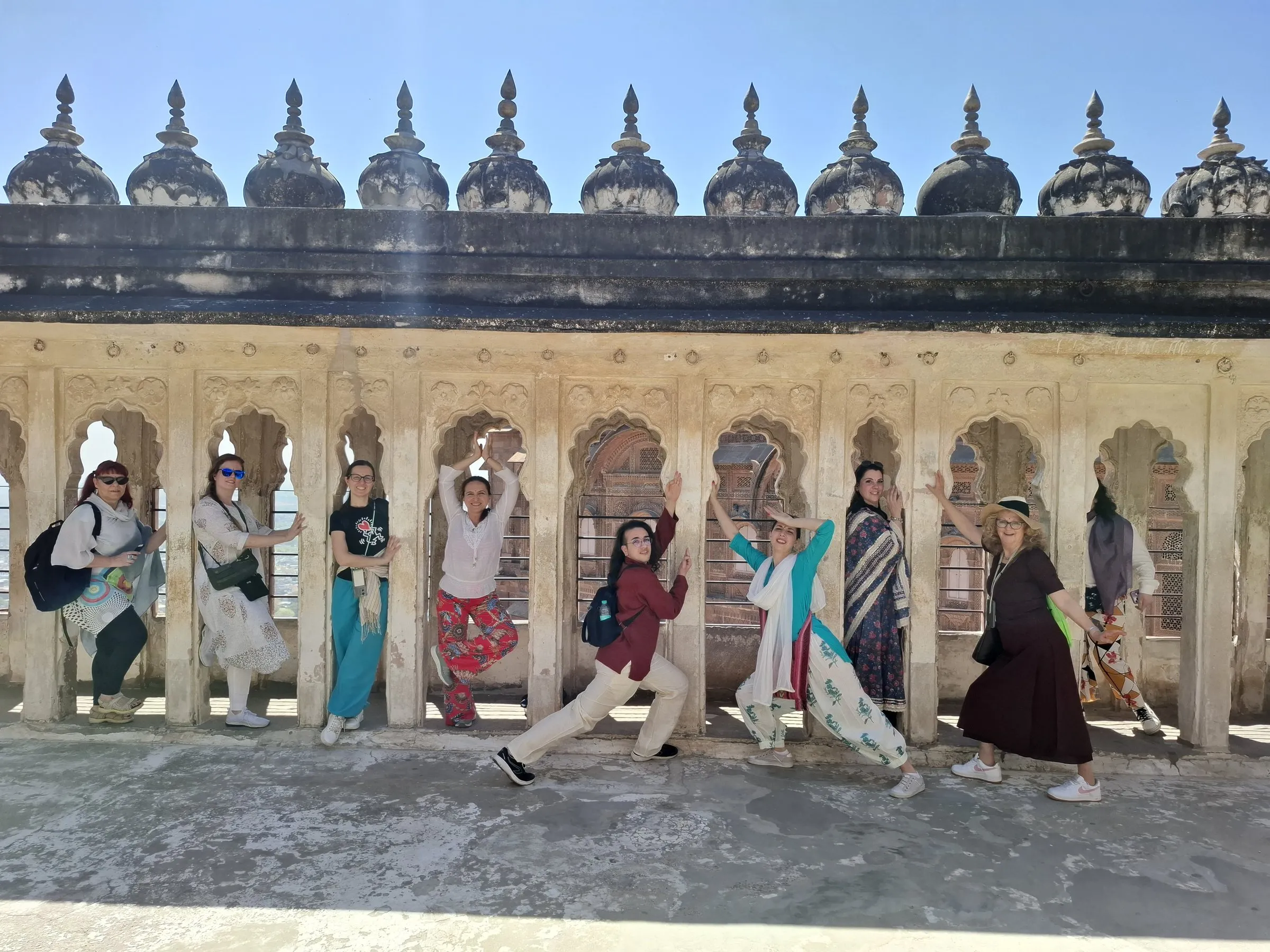 Travellers along a colonnade of sandstone chhatris