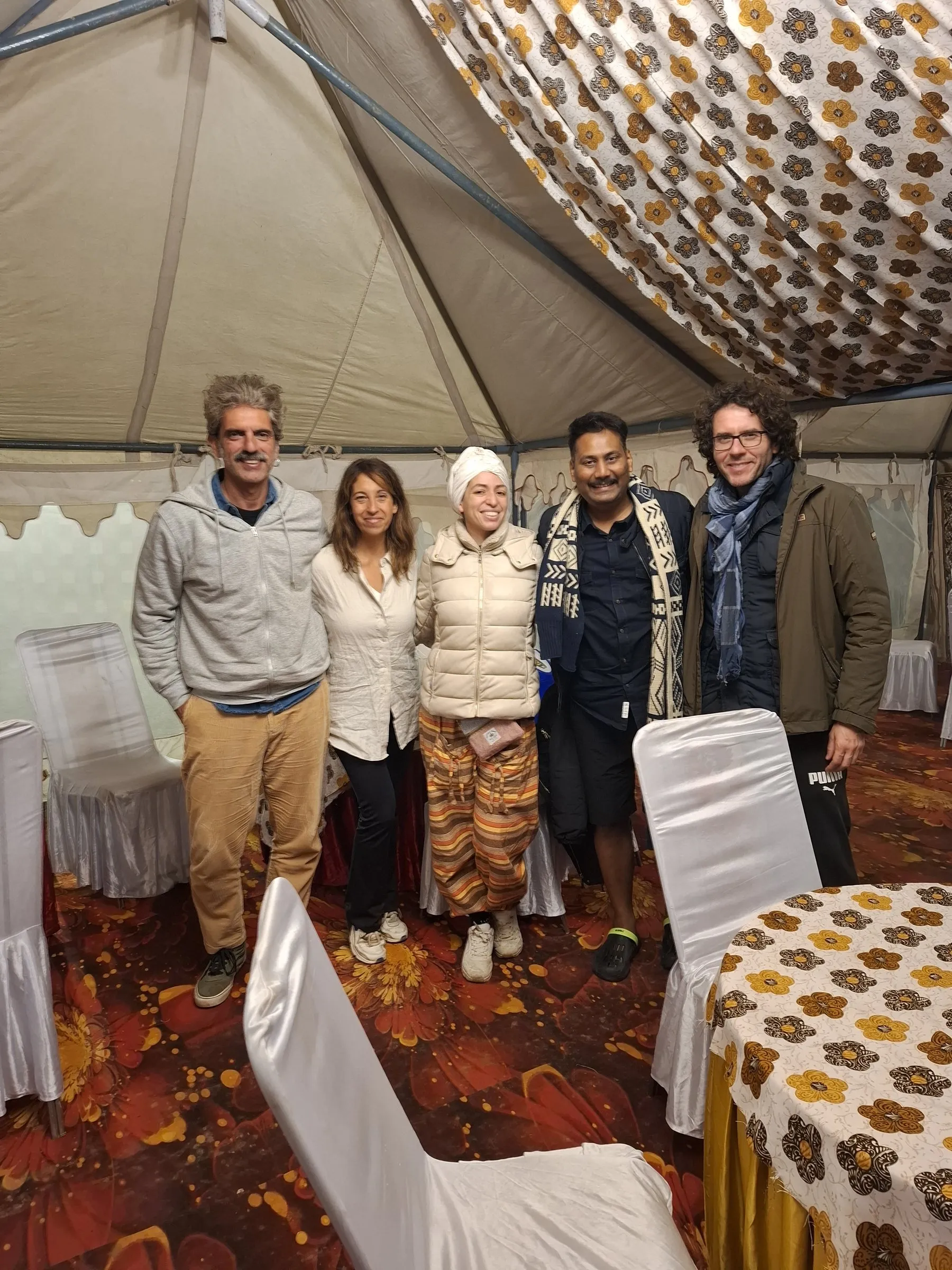 Travellers with the team inside a tent at the Kumbh camp