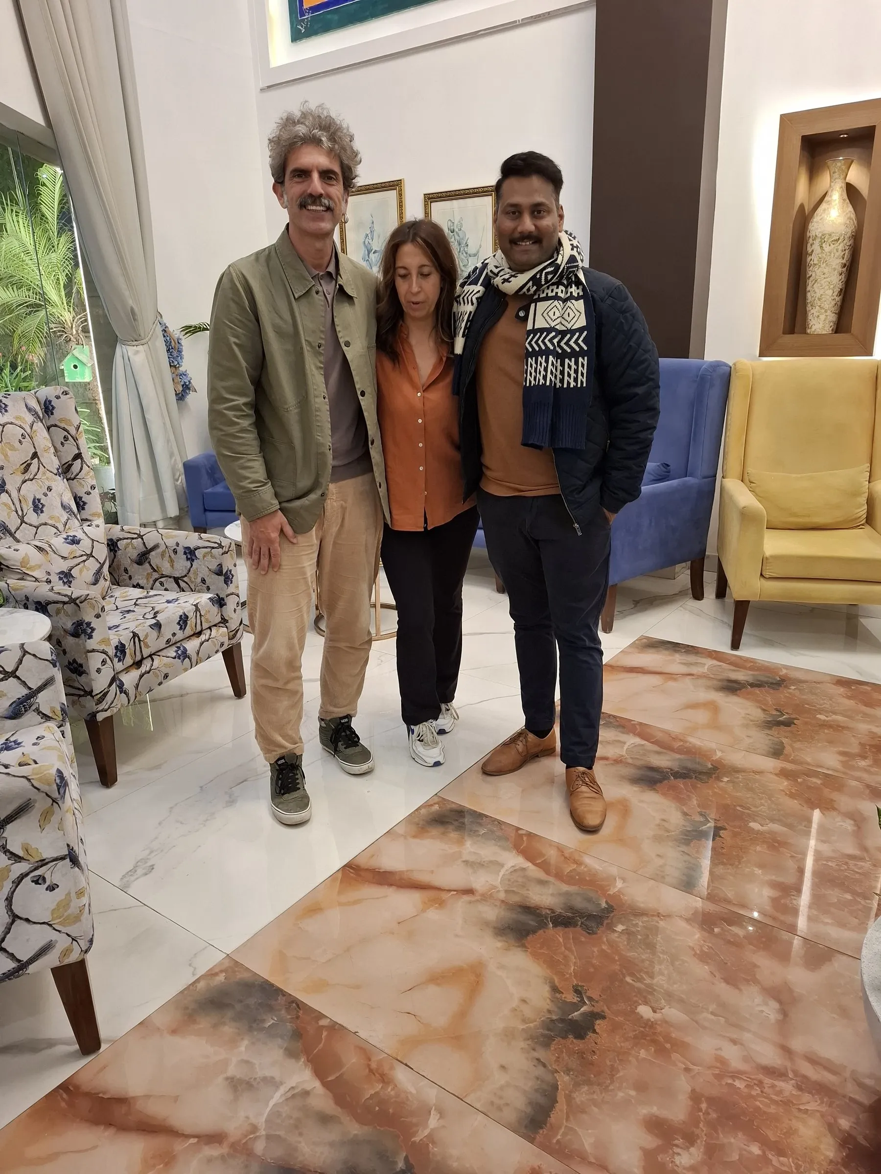 Two travellers with a member of the team in a hotel lobby