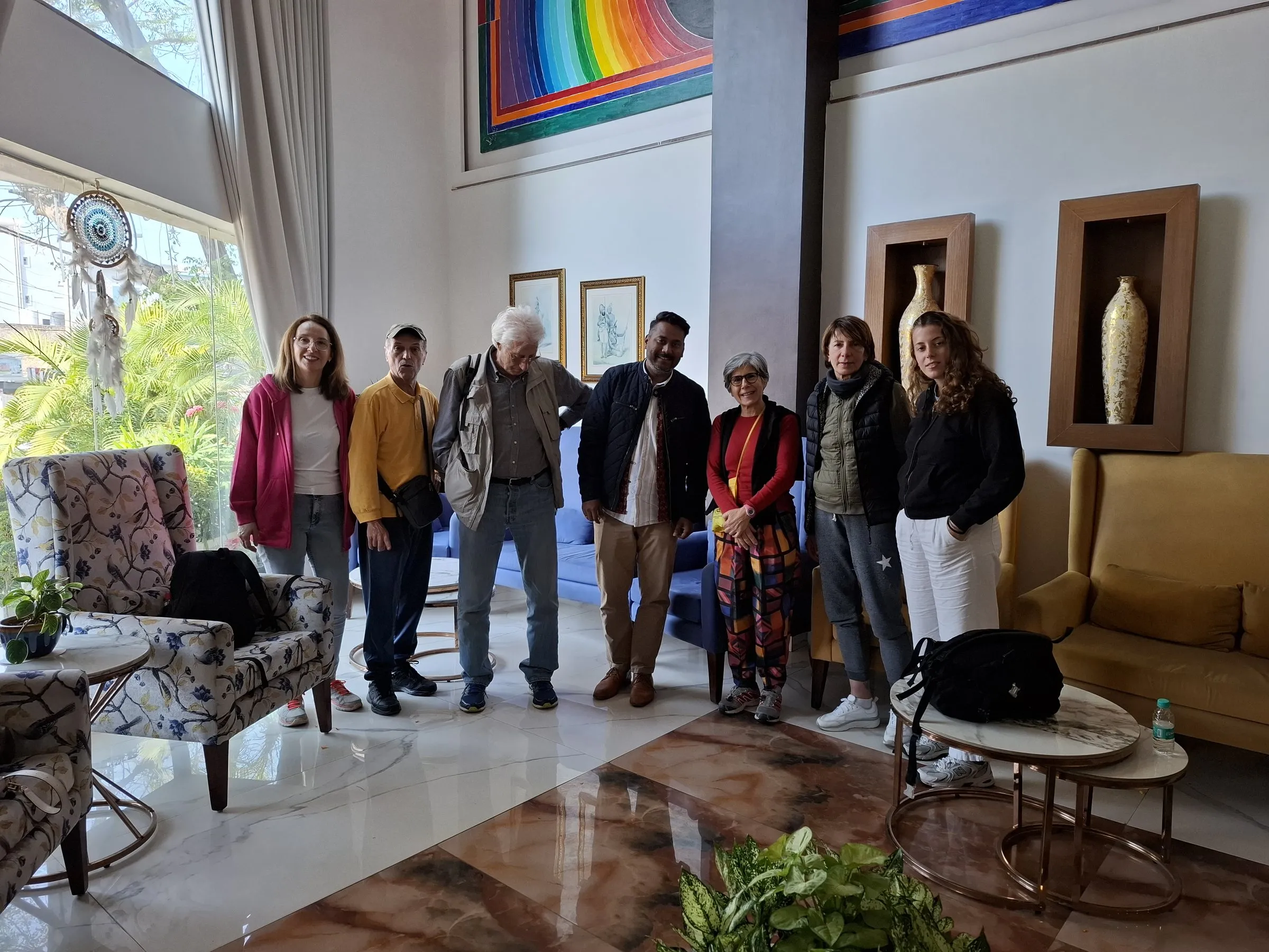 A group of travellers with the team in a hotel lobby