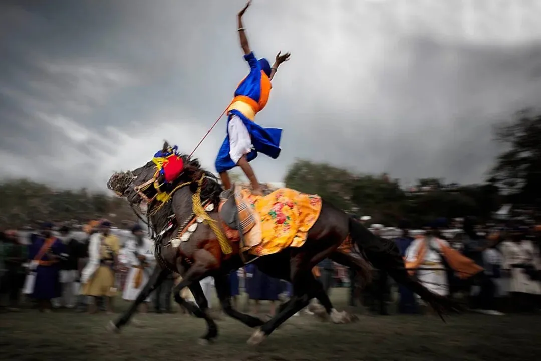 A Nihang horseman with a raised spear at Hola Mohalla