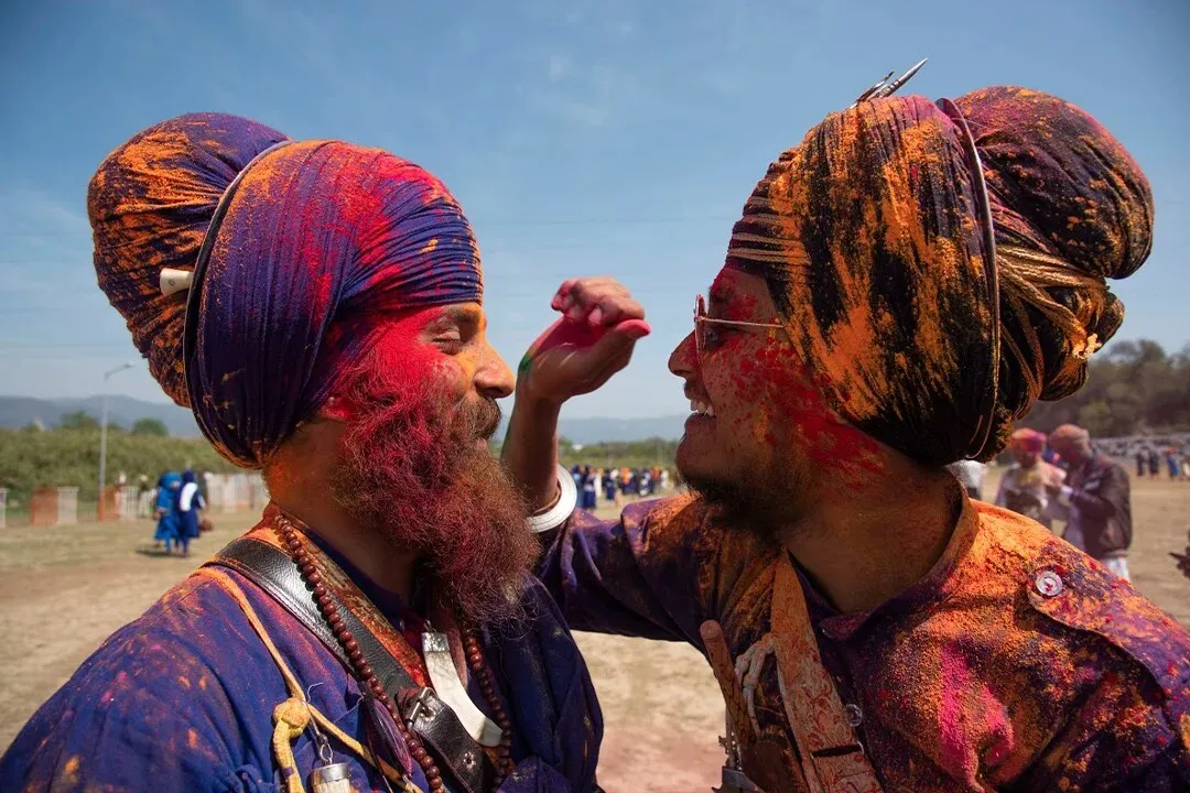 Two Nihang Sikhs playing Holi at Hola Mohalla