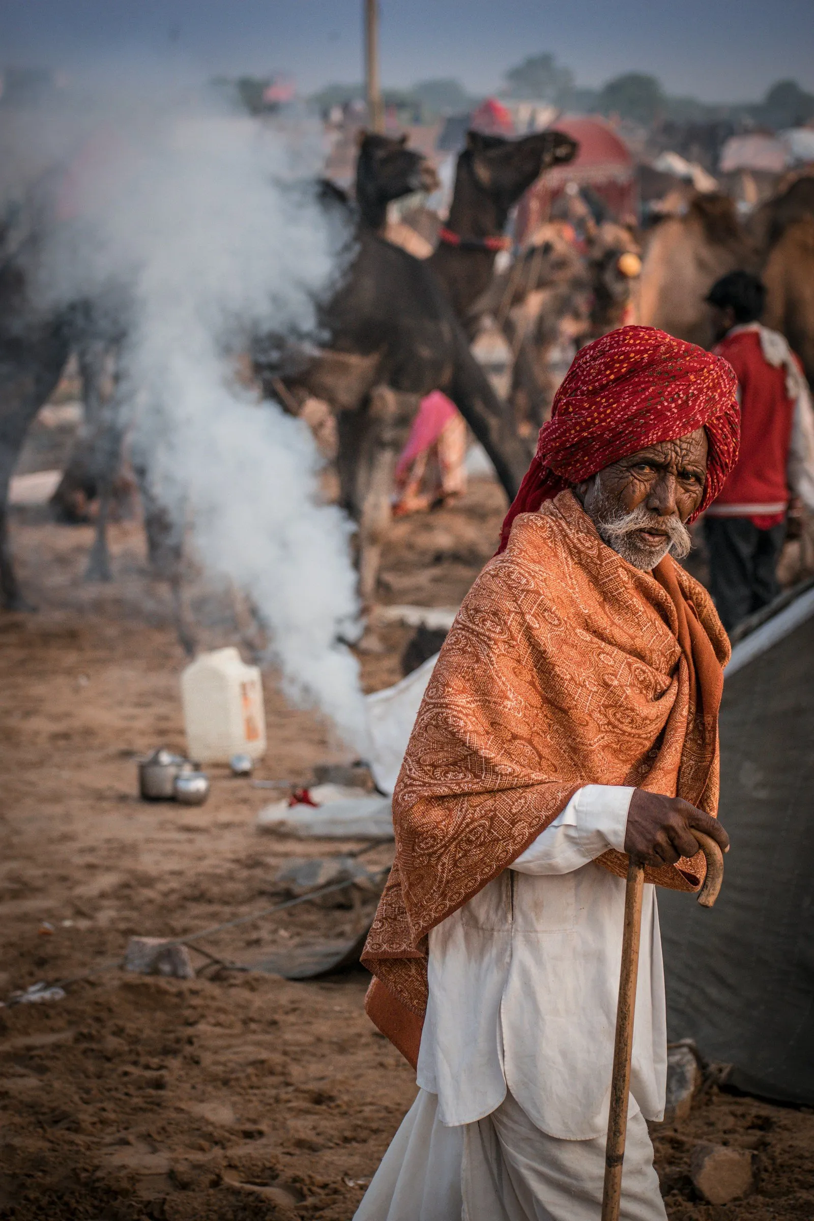 An elder in a red pagdi and shawl at the Pushkar camel fair