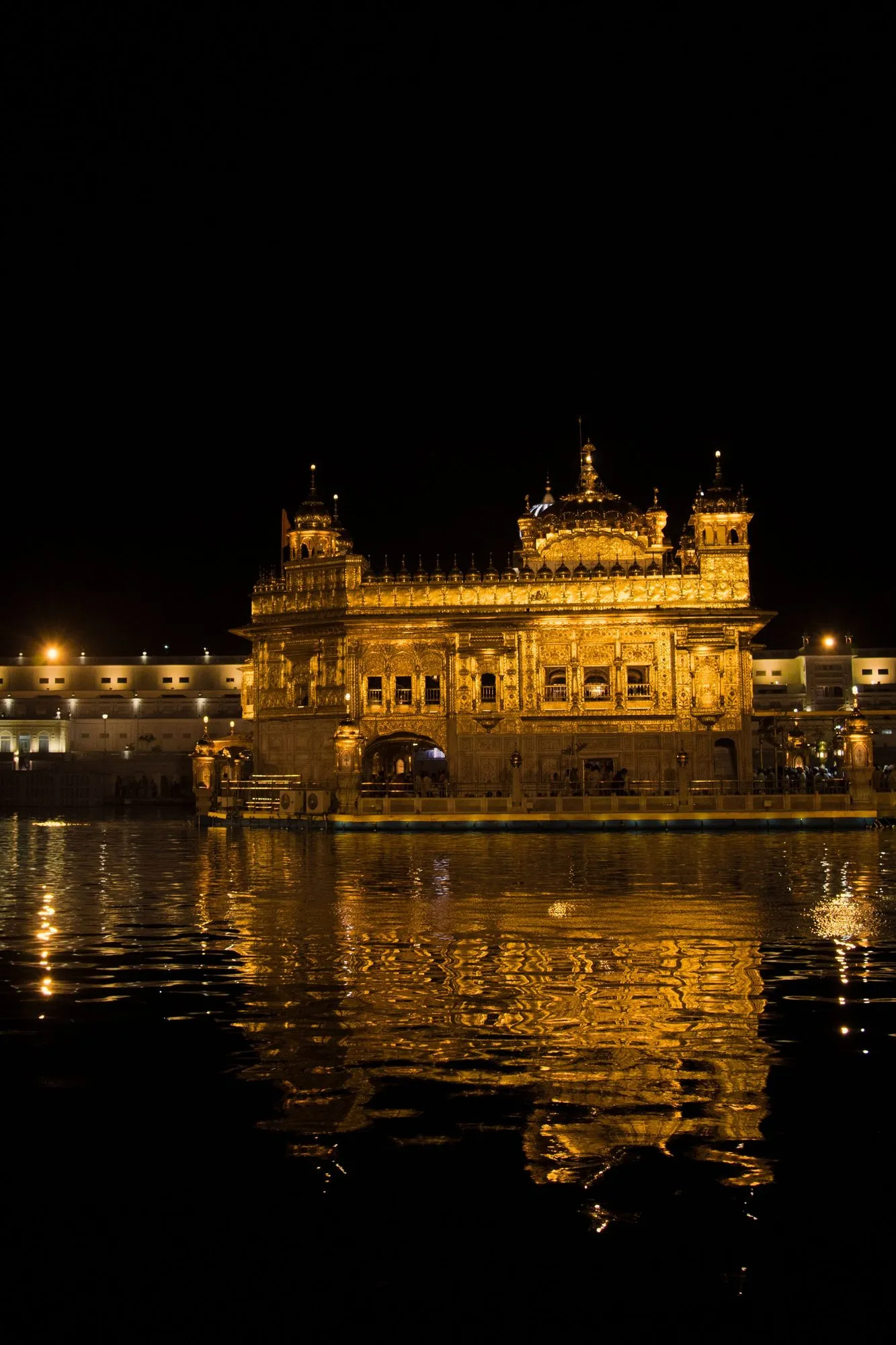 The Golden Temple lit up and reflected in its pool at night