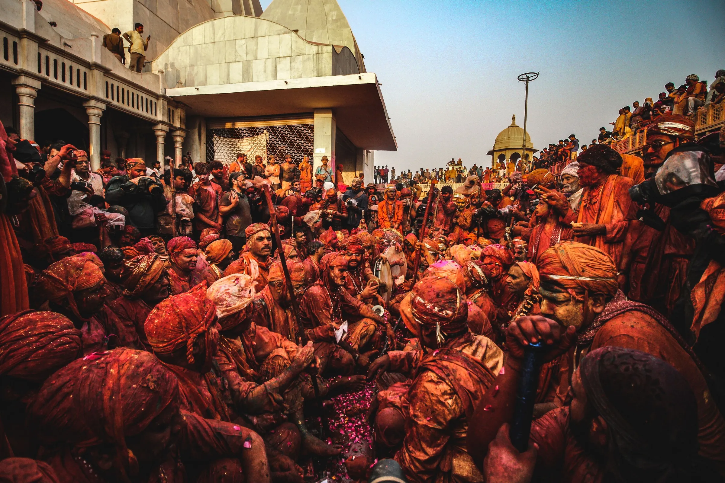 A crowd covered in coloured powder at Barsana during Lathmar Holi