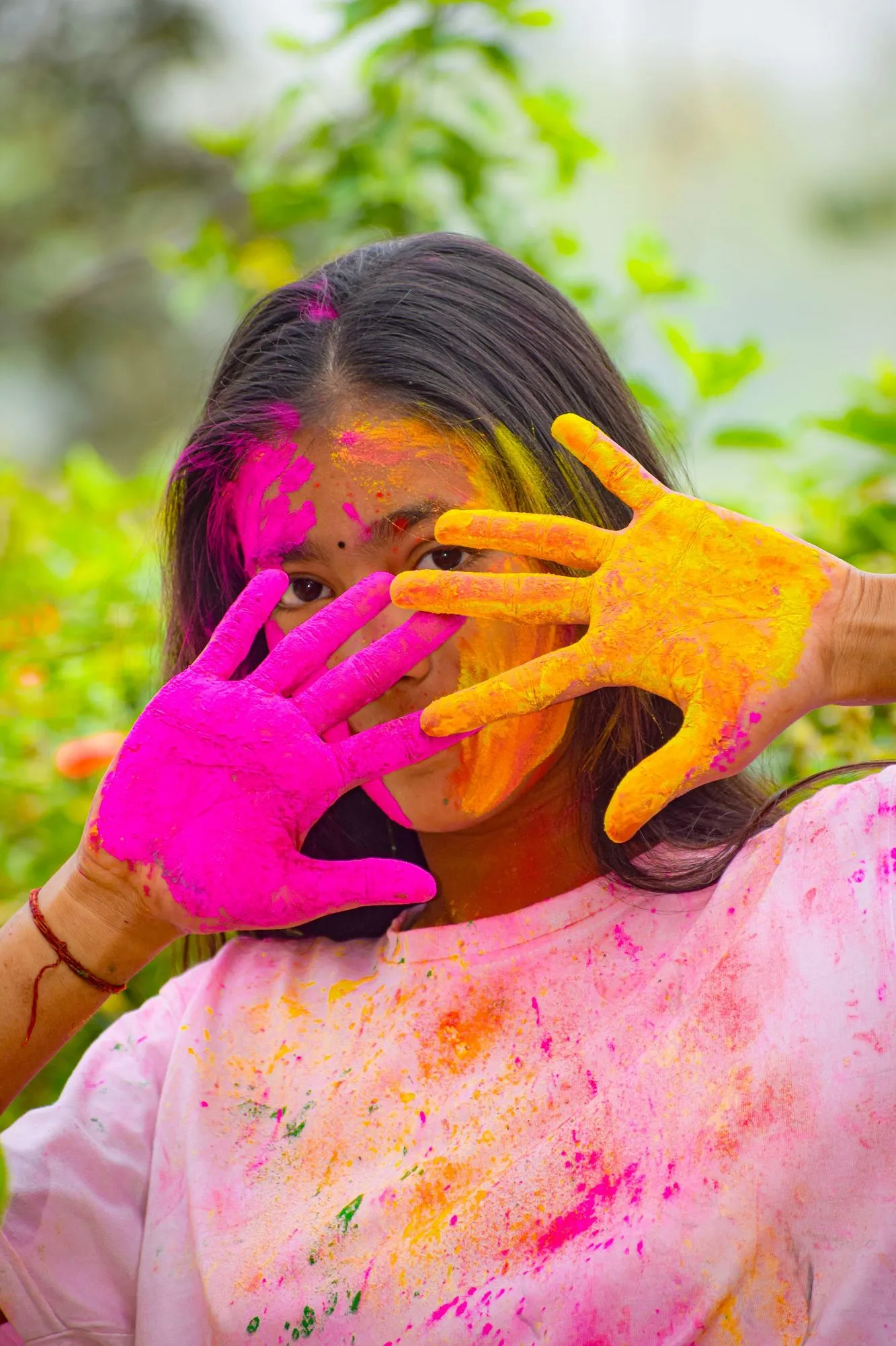 A girl with colour-stained hands at Holi