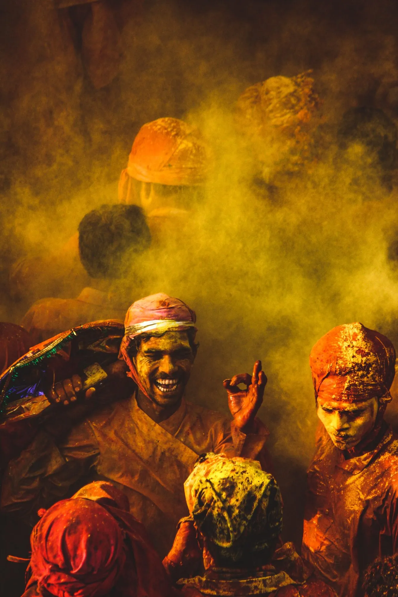 A man laughing through a haze of orange colour at a Vrindavan temple