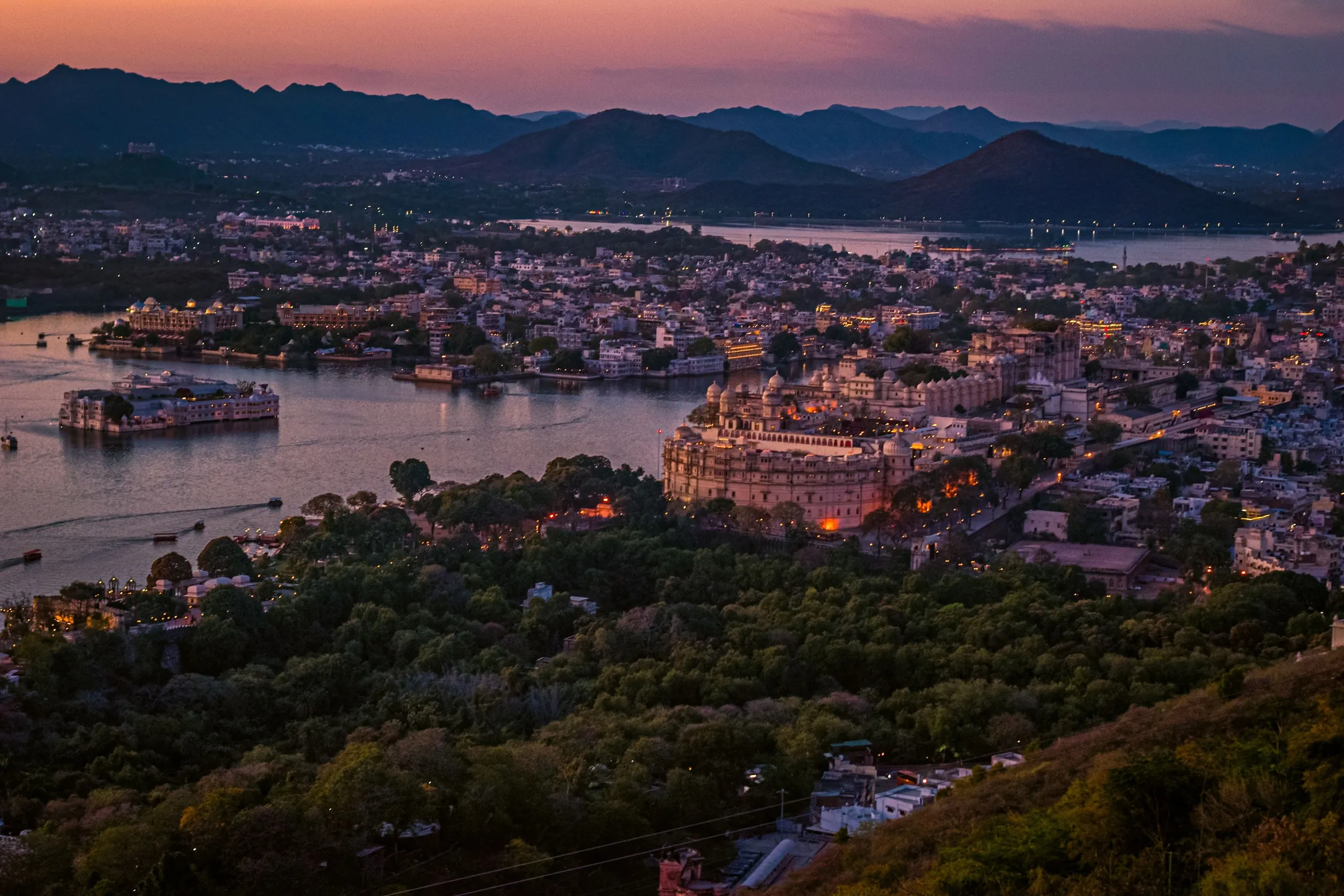 Udaipur and Lake Pichola at dusk, palaces lit along the water