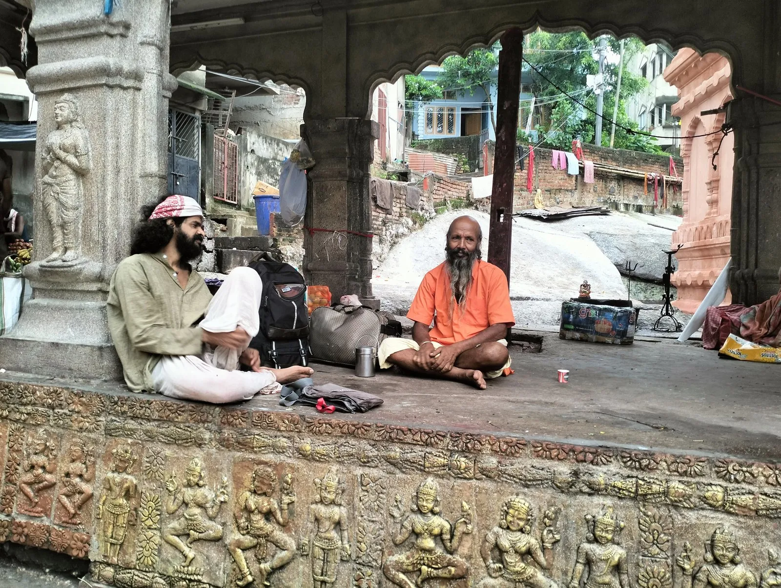 Two holy men seated on the carved plinth of the Kamakhya temple, Guwahati