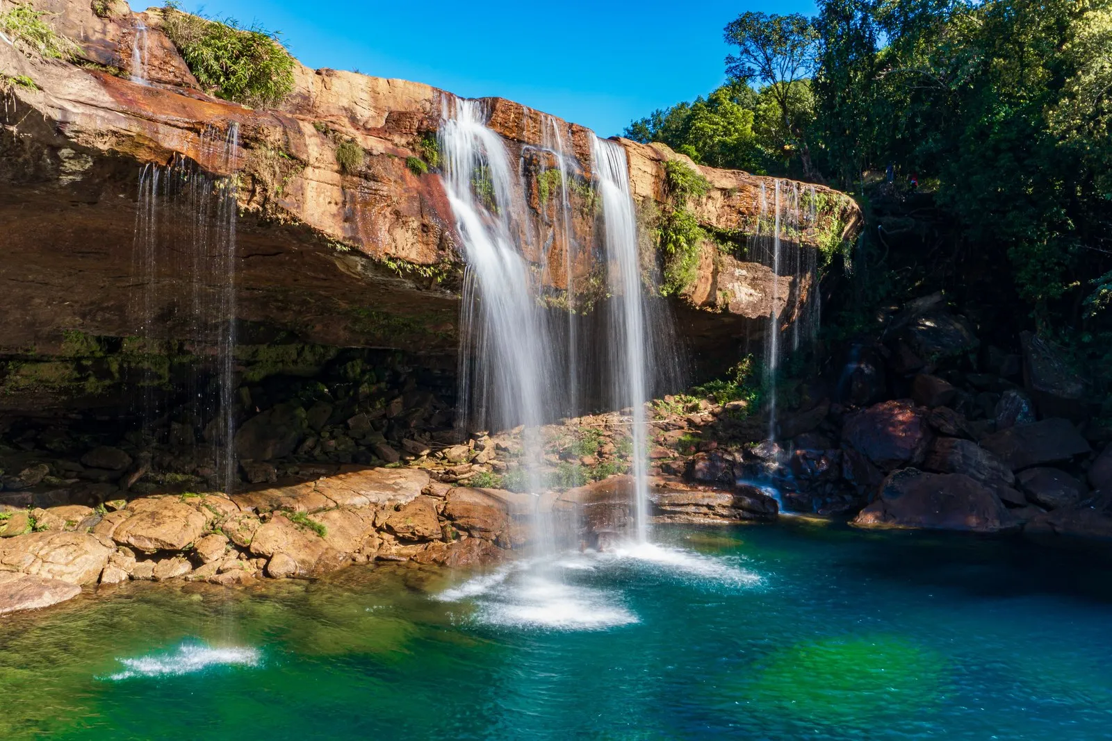 Krang Suri falls pouring from a sandstone ledge into a blue pool, Jaintia Hills