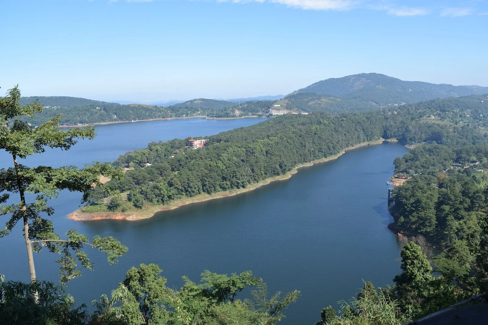 Umiam Lake and its wooded islands below the hills, on the road to Shillong