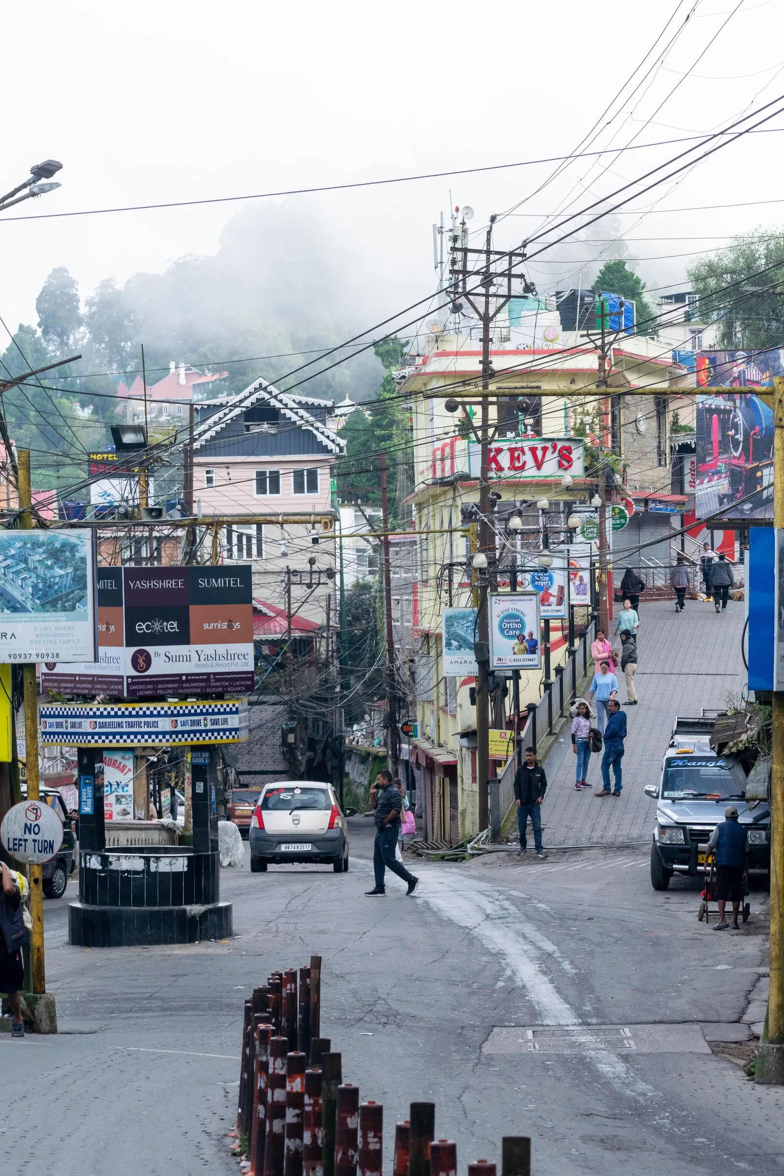 A steep street in Darjeeling on a misty morning