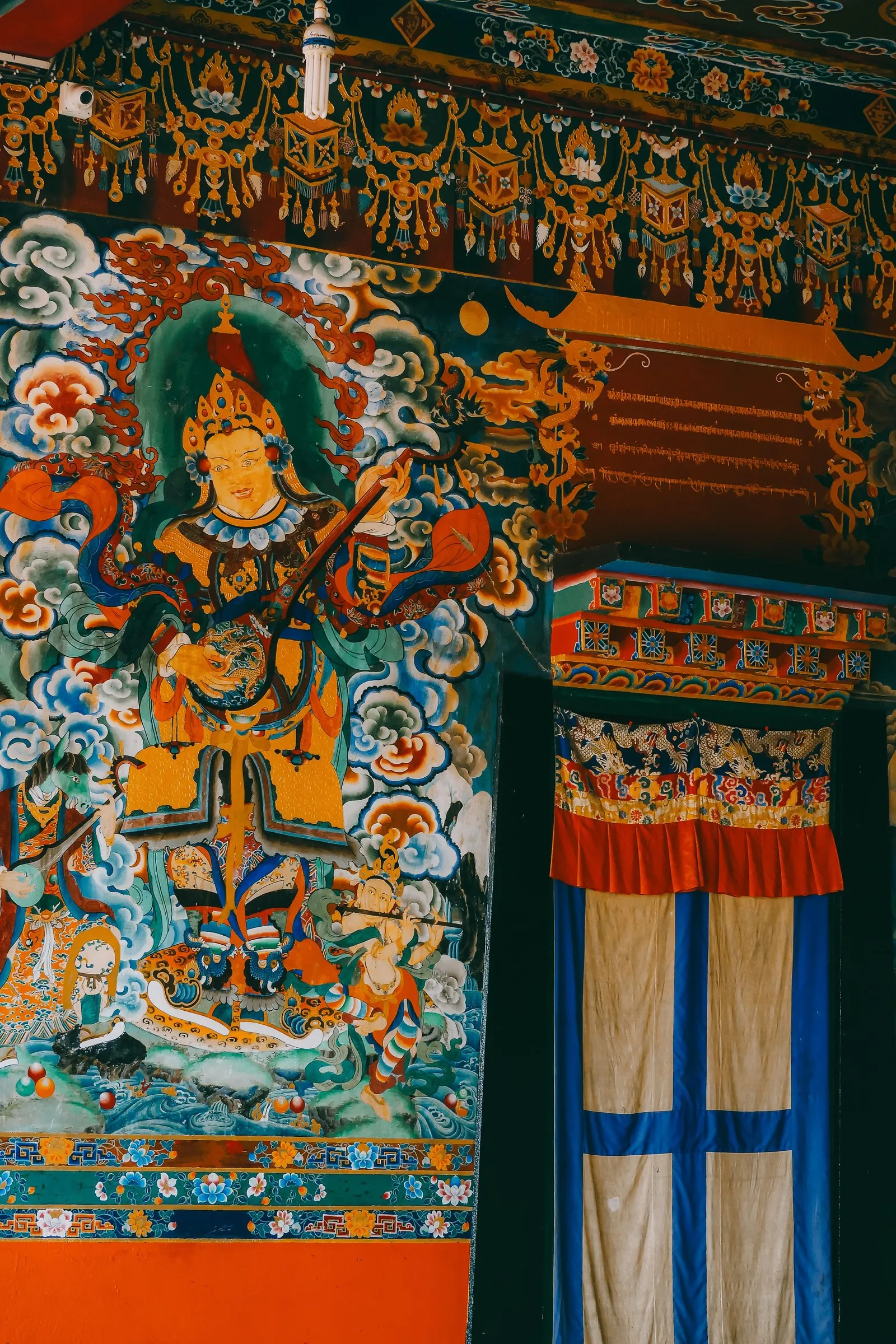 A painted mural at the entrance to Rumtek Monastery, Sikkim