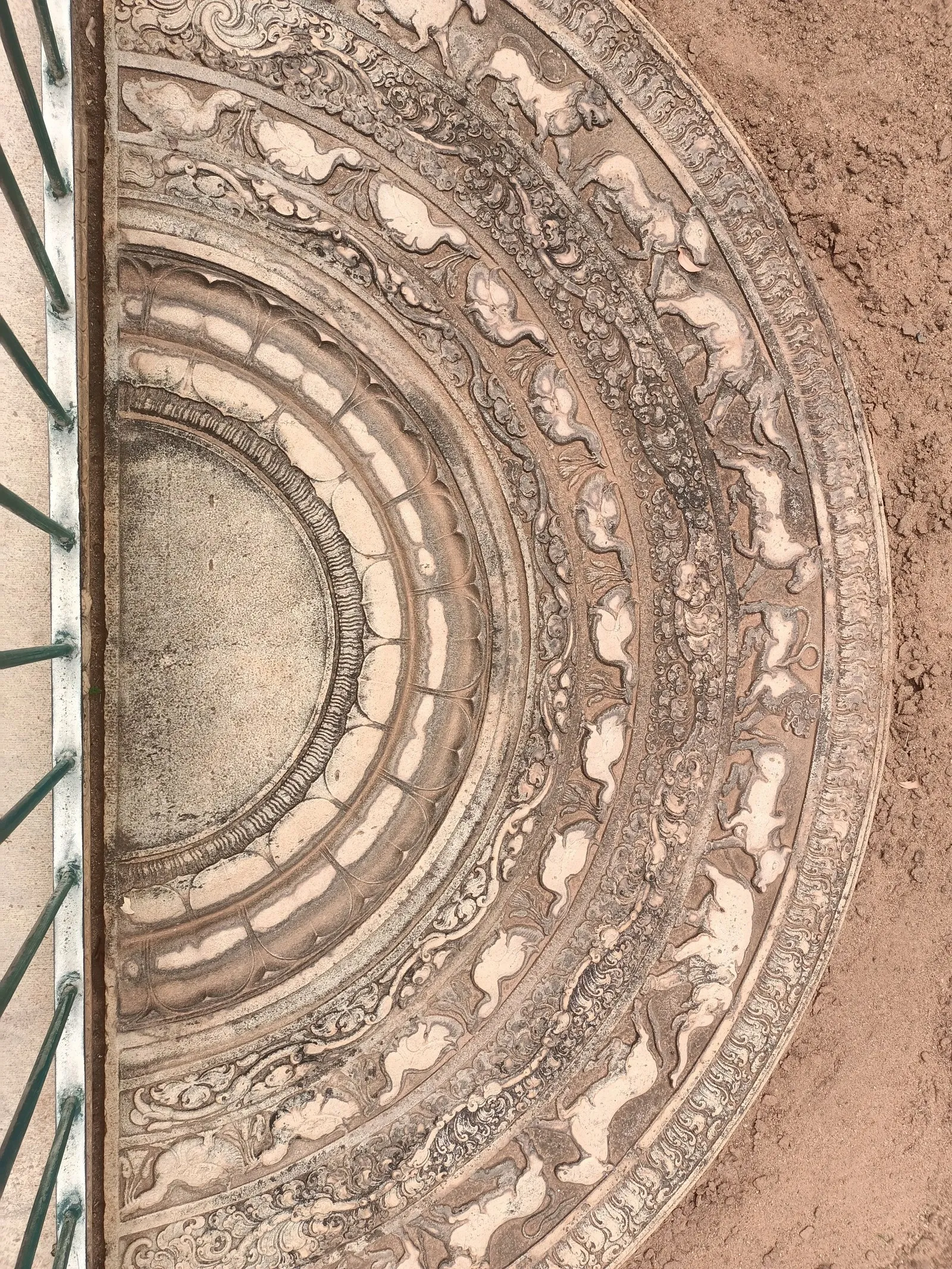 A carved moonstone at the foot of temple steps in Anuradhapura