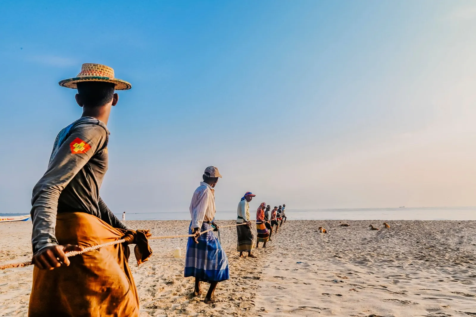 Fishermen hauling in a beach-seine net on a Sri Lankan beach