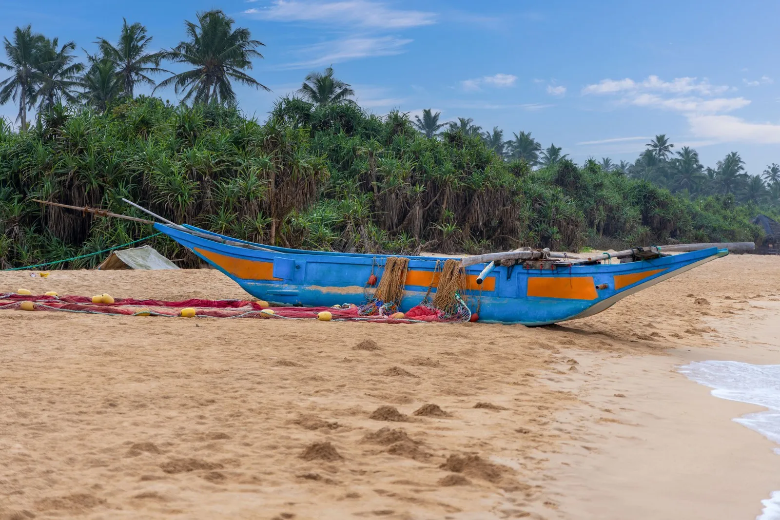 A fishing boat drawn up on the beach at Bentota