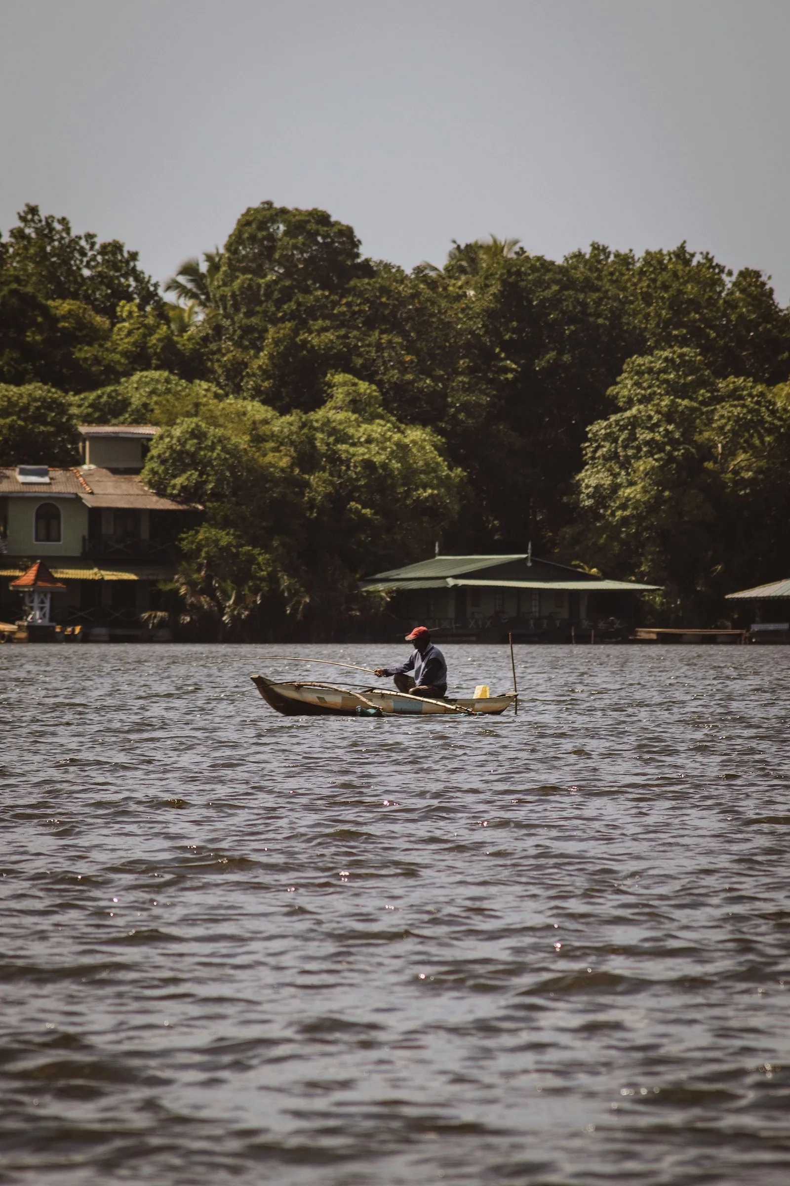 A man paddling a canoe on the Bentota River