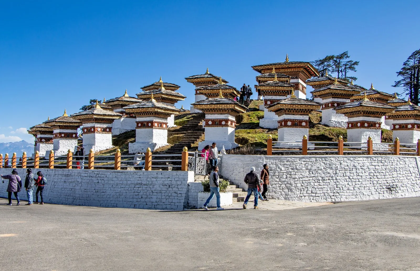 The chortens of Dochu La on their terraced knoll, visitors below