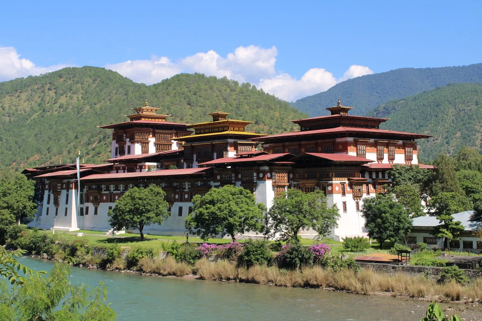 Punakha Dzong on the river, below forested hills