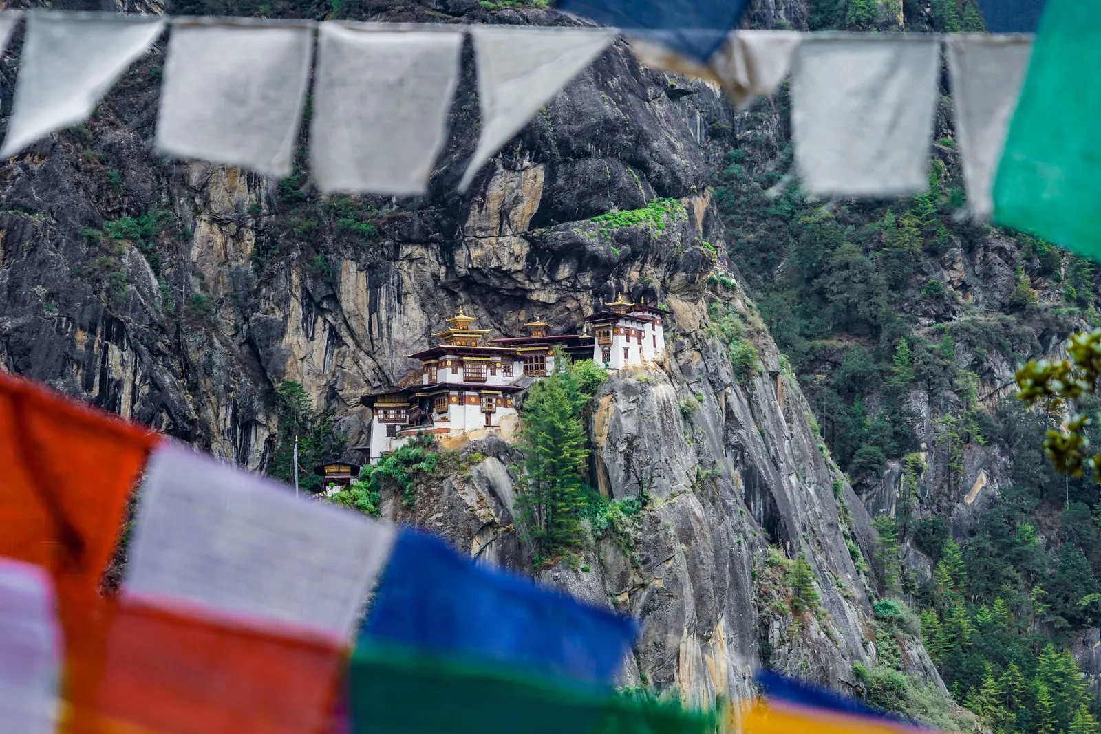 The Tiger’s Nest on its cliff above the Paro valley, seen through prayer flags