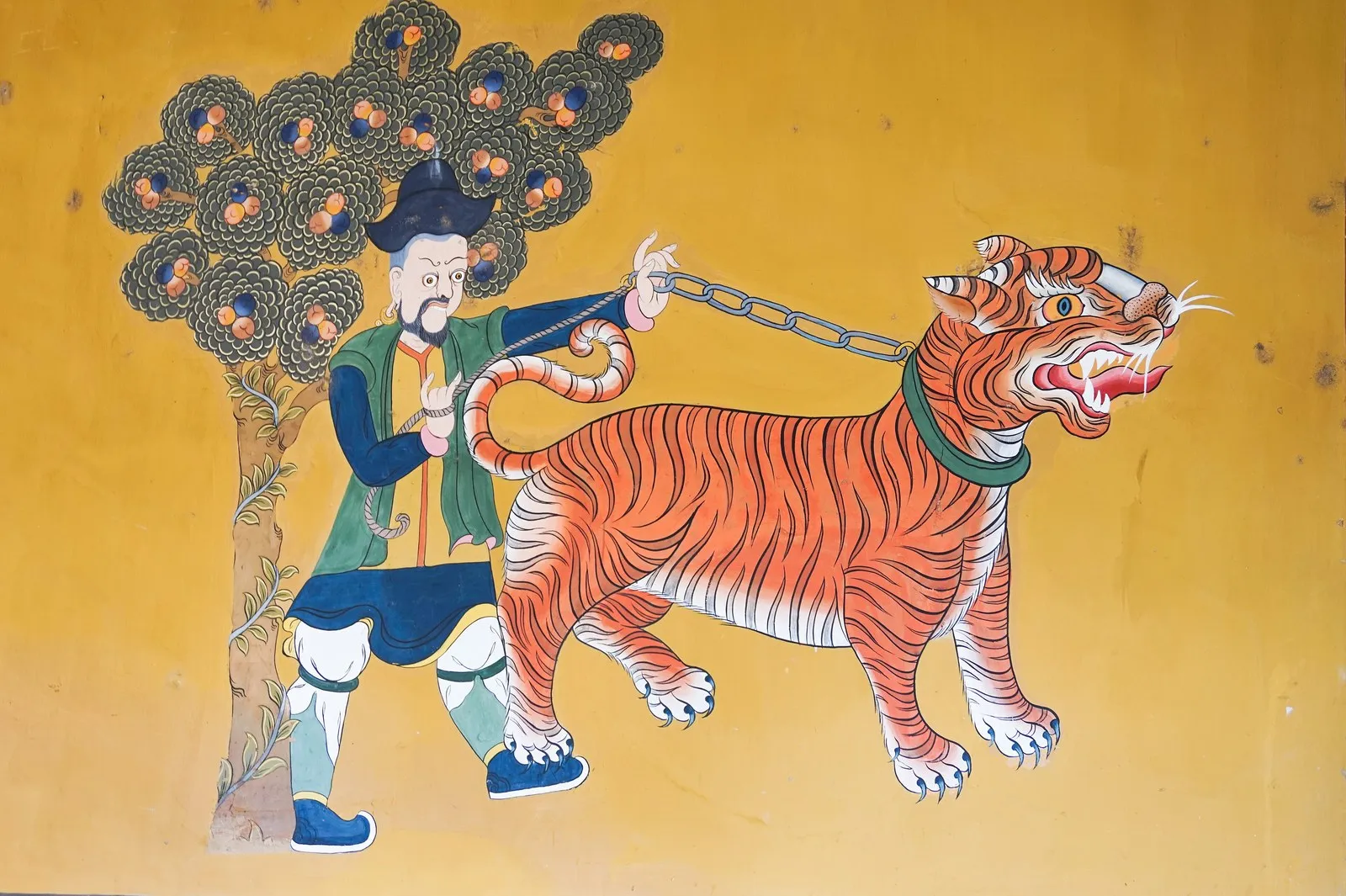 A wall painting of a man leading a tiger, Rinpung Dzong, Paro