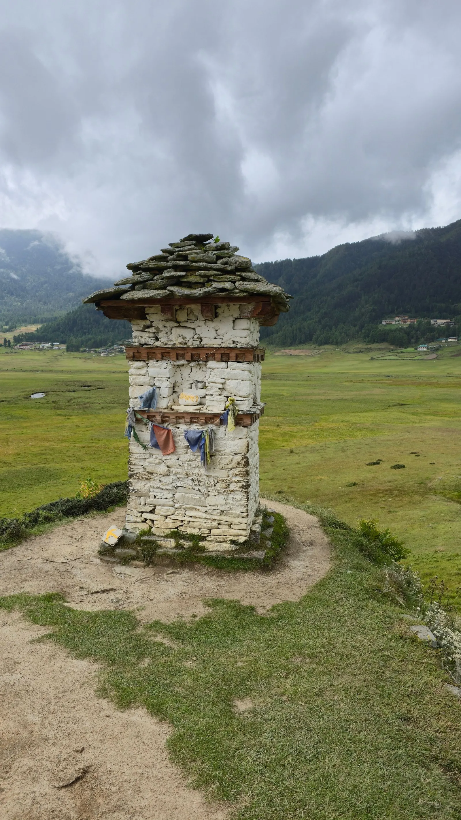 A chorten on the open grassland of a high valley in Wangdue Phodrang