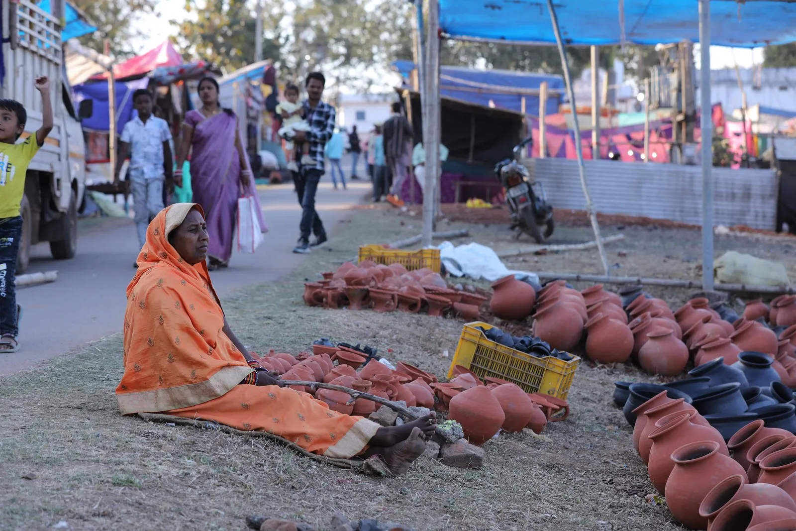 A woman selling clay pots at a market in Kota, Chhattisgarh