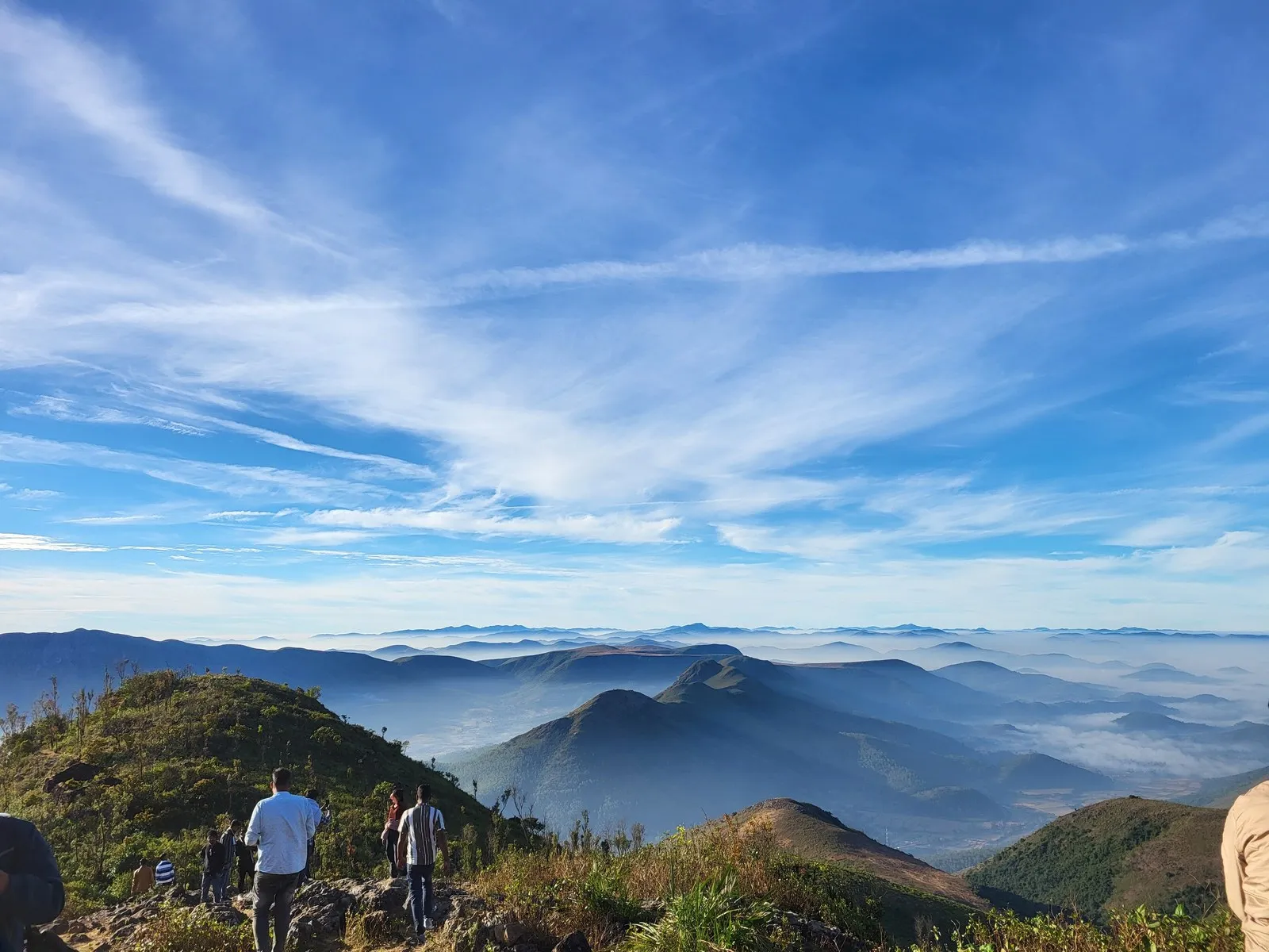 Walkers on Deomali, the highest hill in Odisha, above a sea of cloud