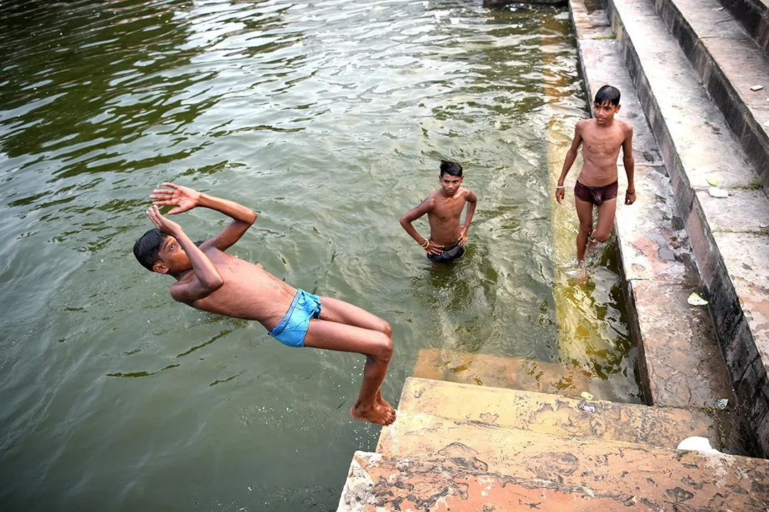 Boys diving from the river steps