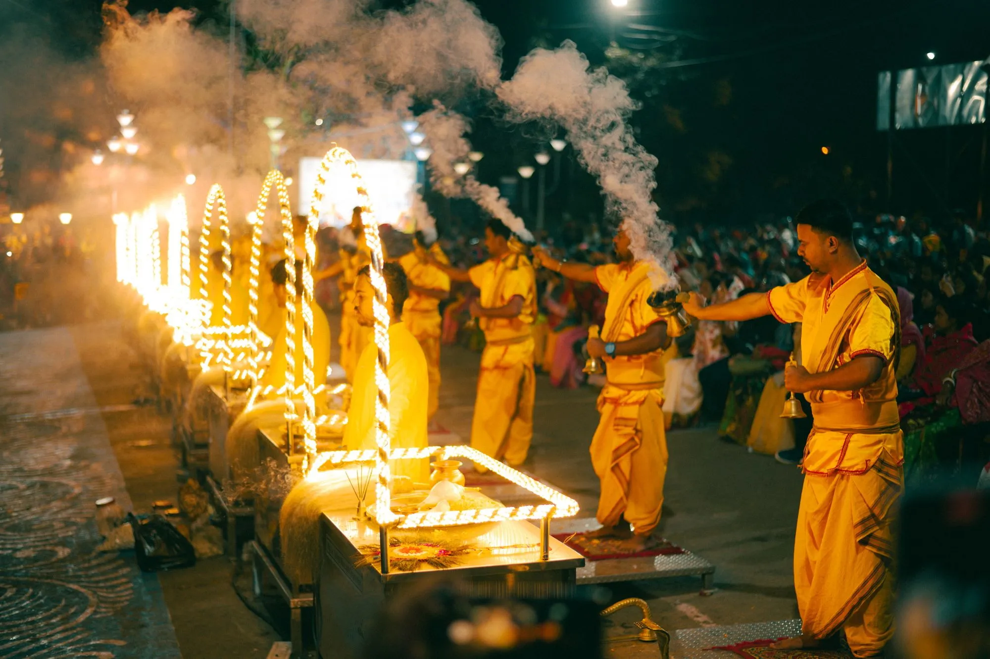 Priests raising fire lamps at the evening Ganga aarti