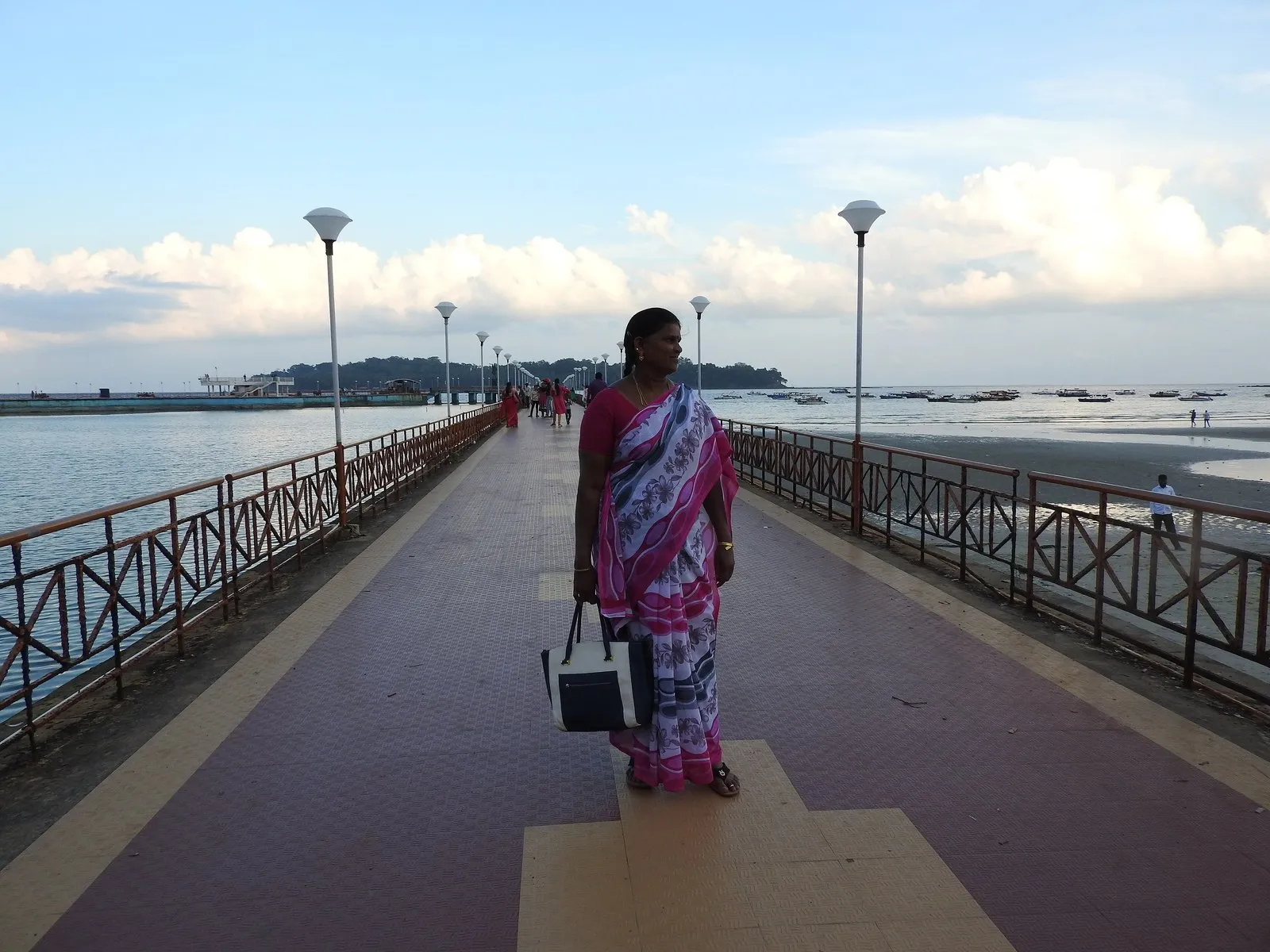 A woman in a sari on the sea promenade at Marina Park, Port Blair