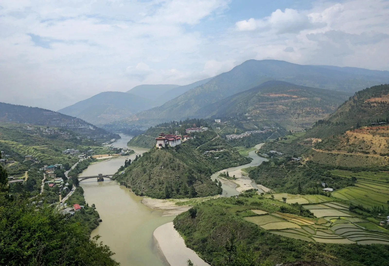 The Punakha valley from above: rice terraces along the river and the dzong at the confluence