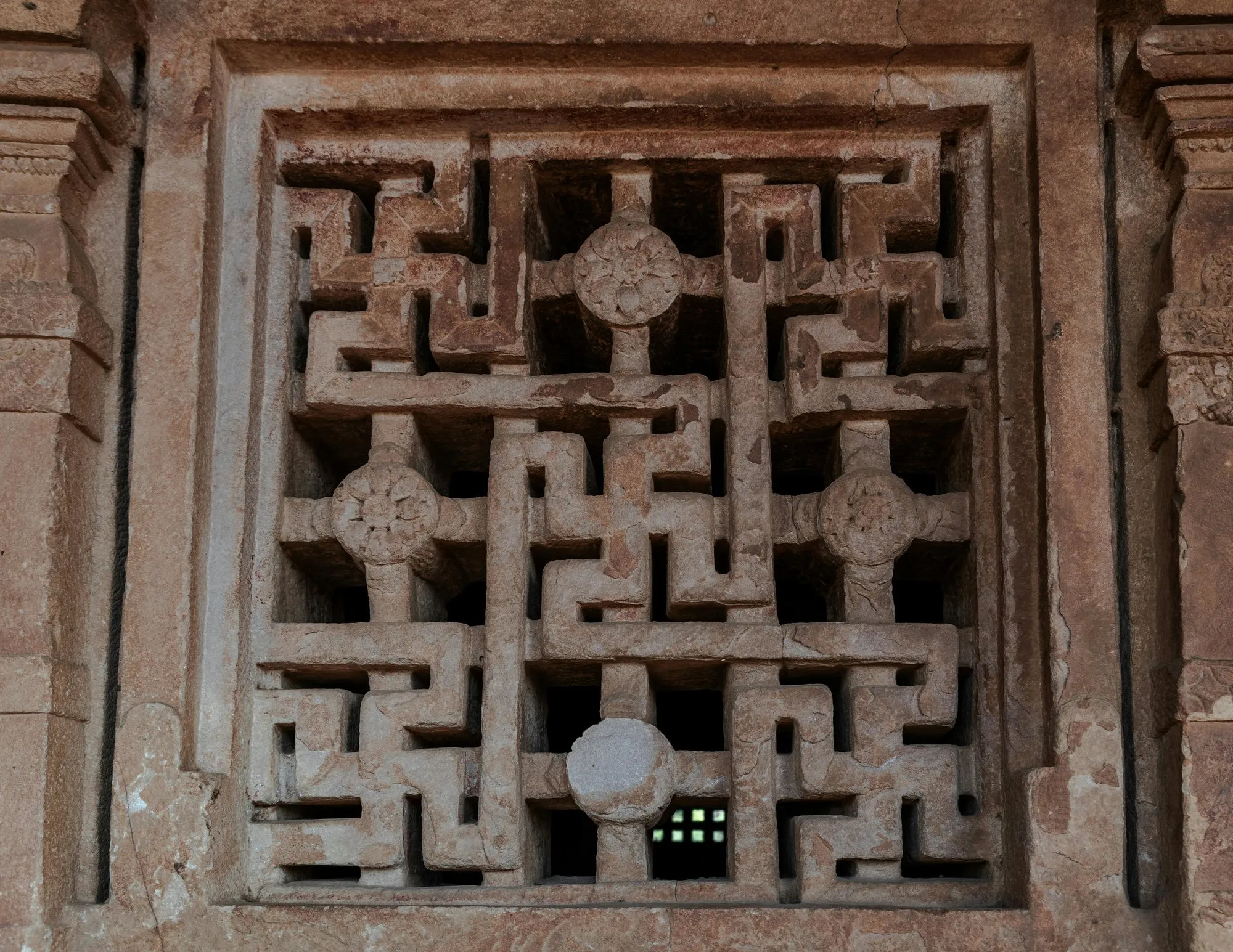 A carved stone jali screen