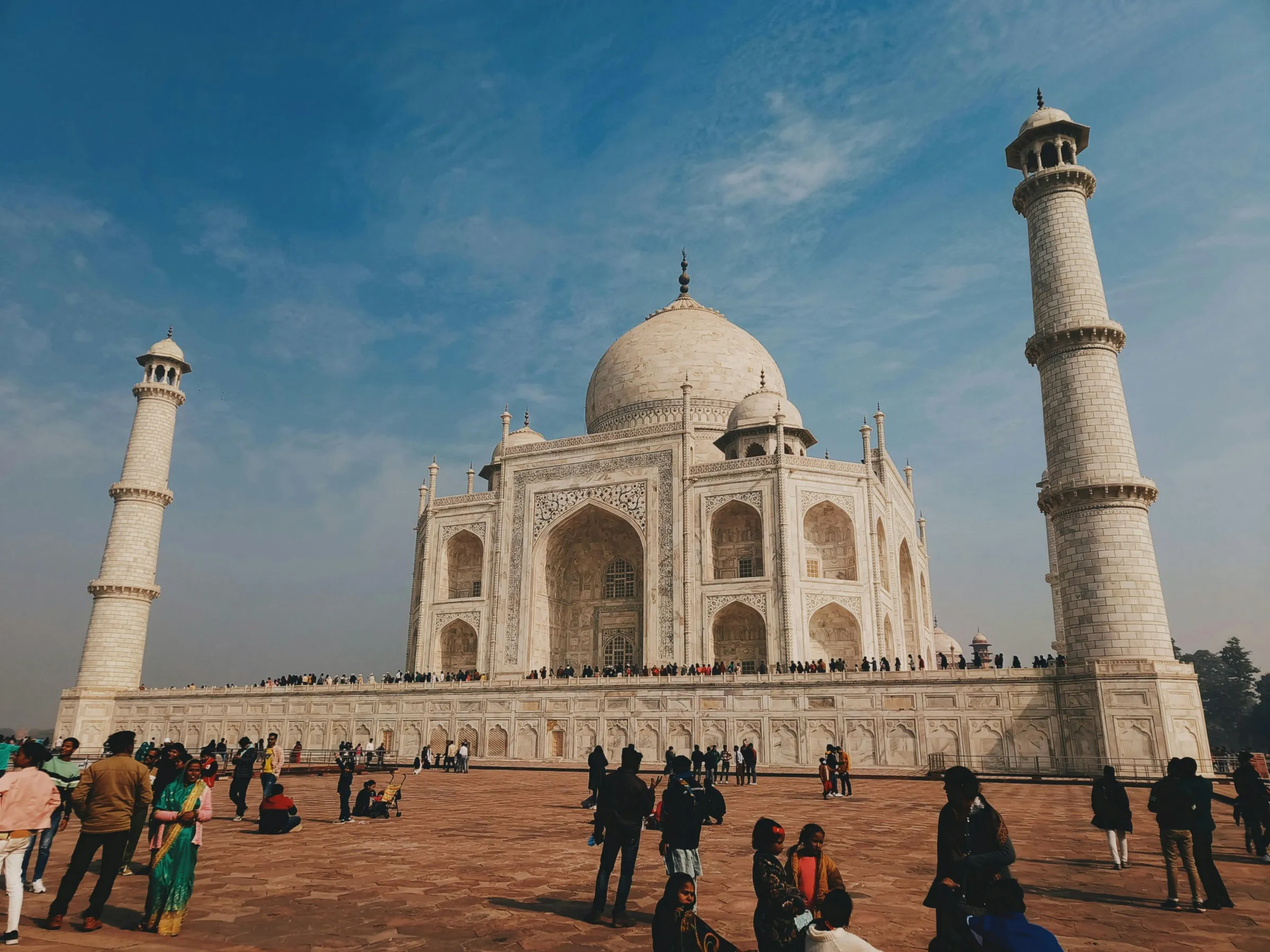 The Taj Mahal and its minarets under a blue sky
