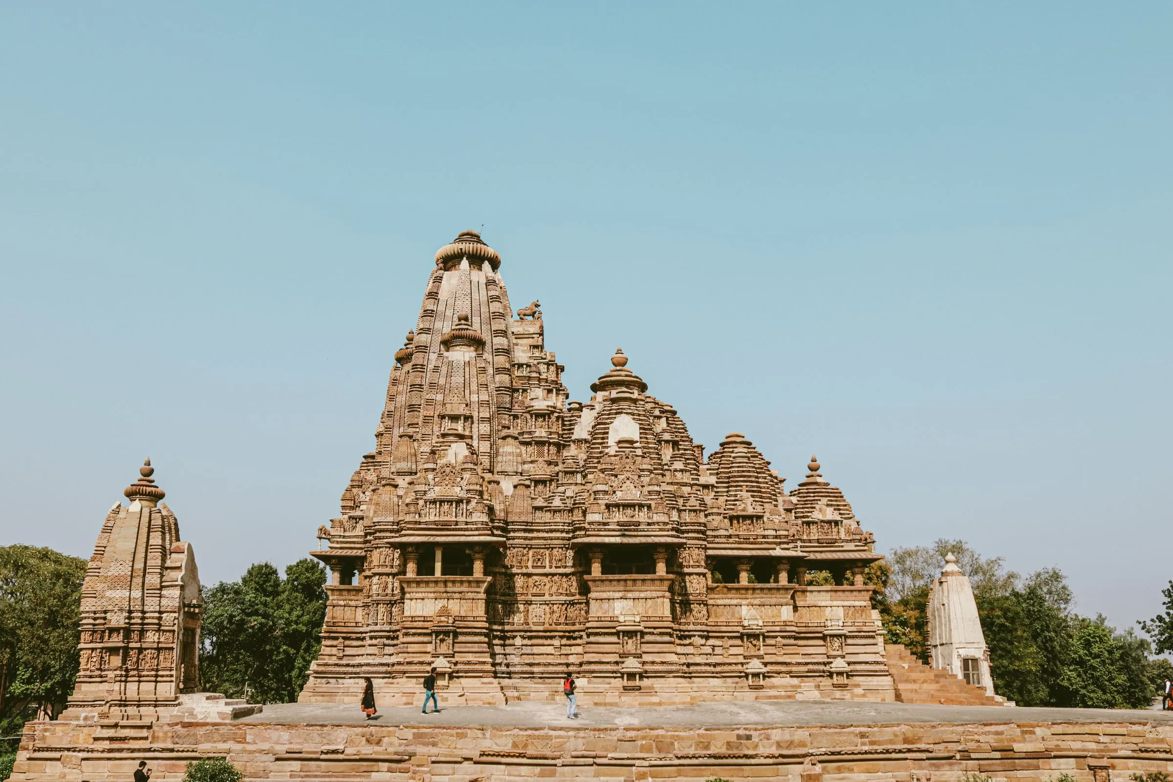A Khajuraho temple, its carved spire complete