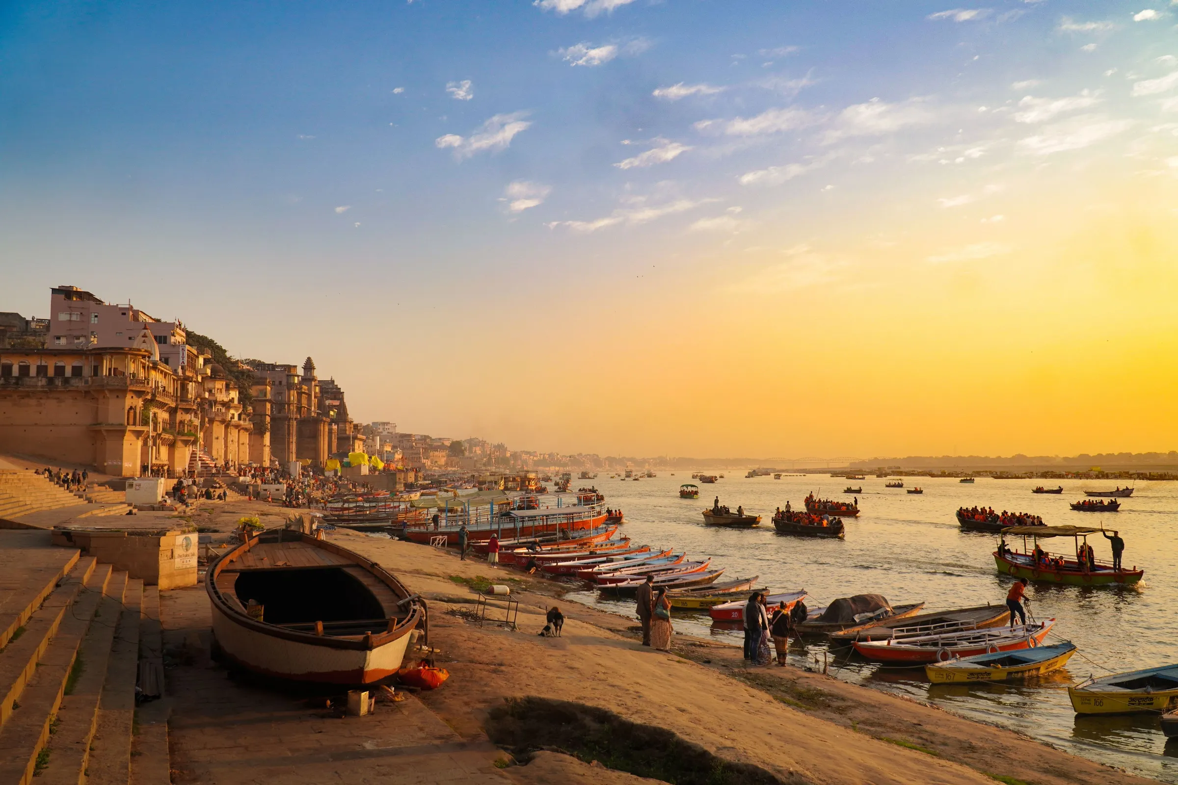 The ghats at Varanasi at sunrise, boats drawn up on the sand