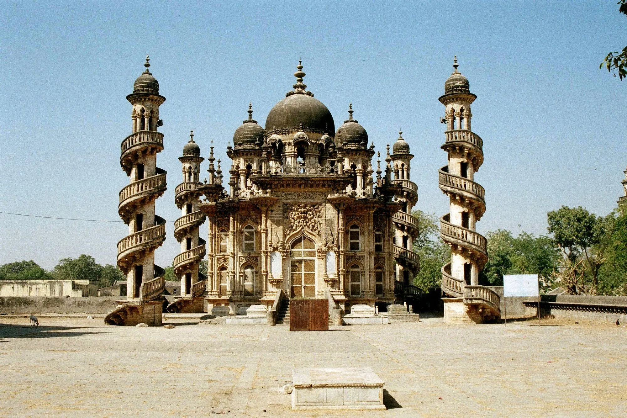 A domed mausoleum with spiral-staired minarets