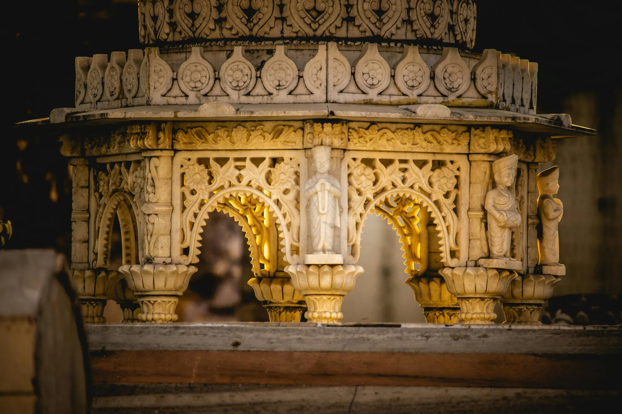 A carved marble shrine lit gold at dusk