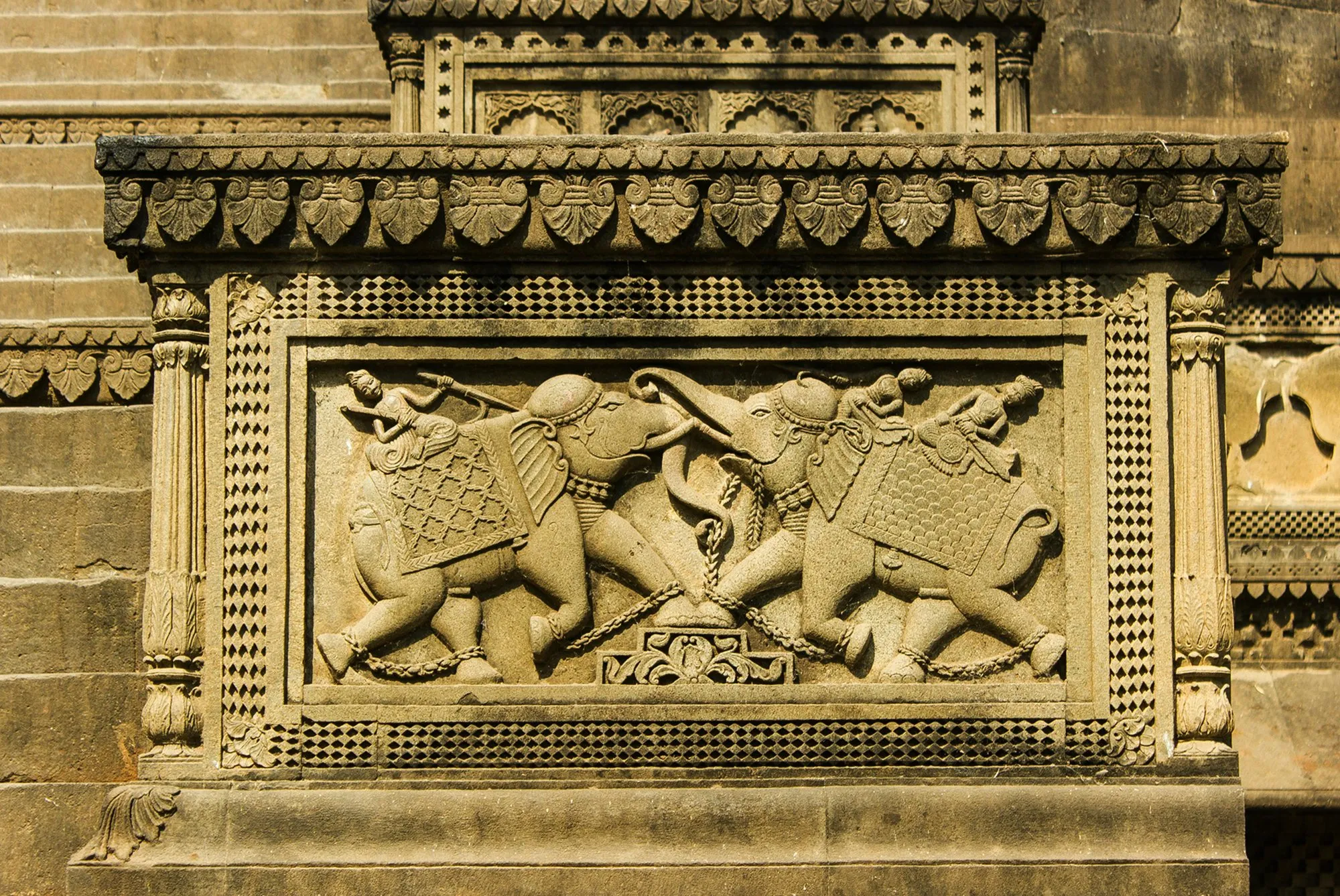 A stone relief of two elephants