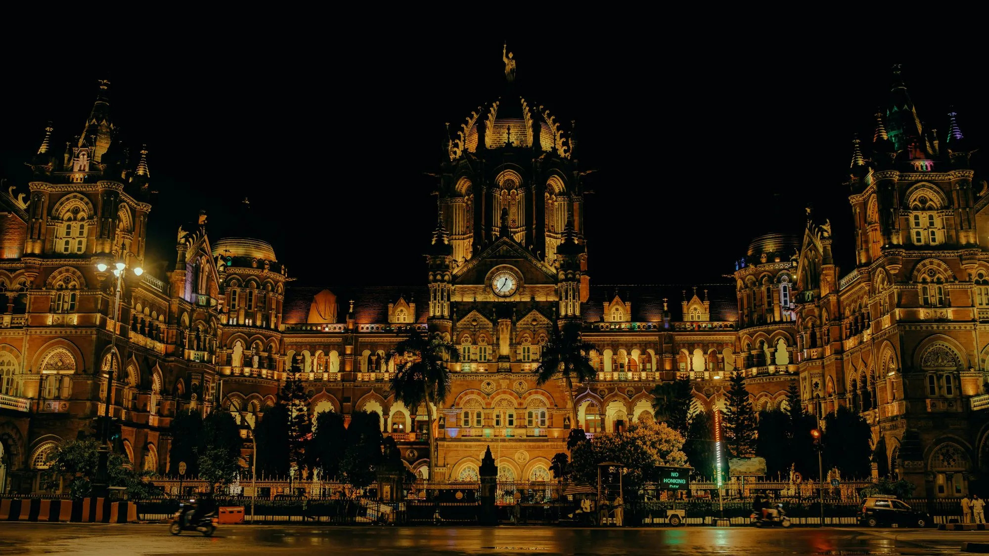 A Gothic railway terminus lit at night