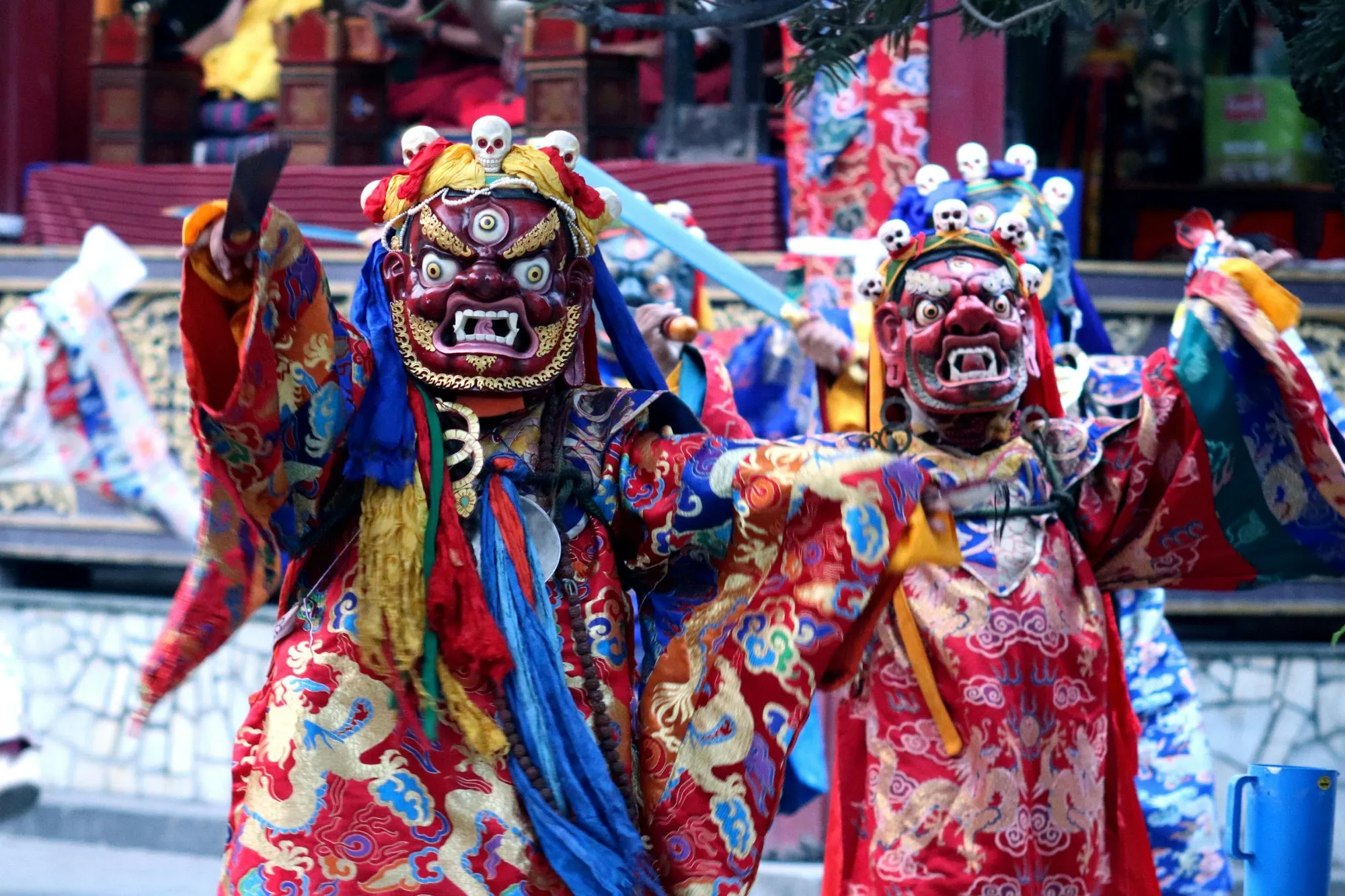 Two masked Cham dancers in brocade robes