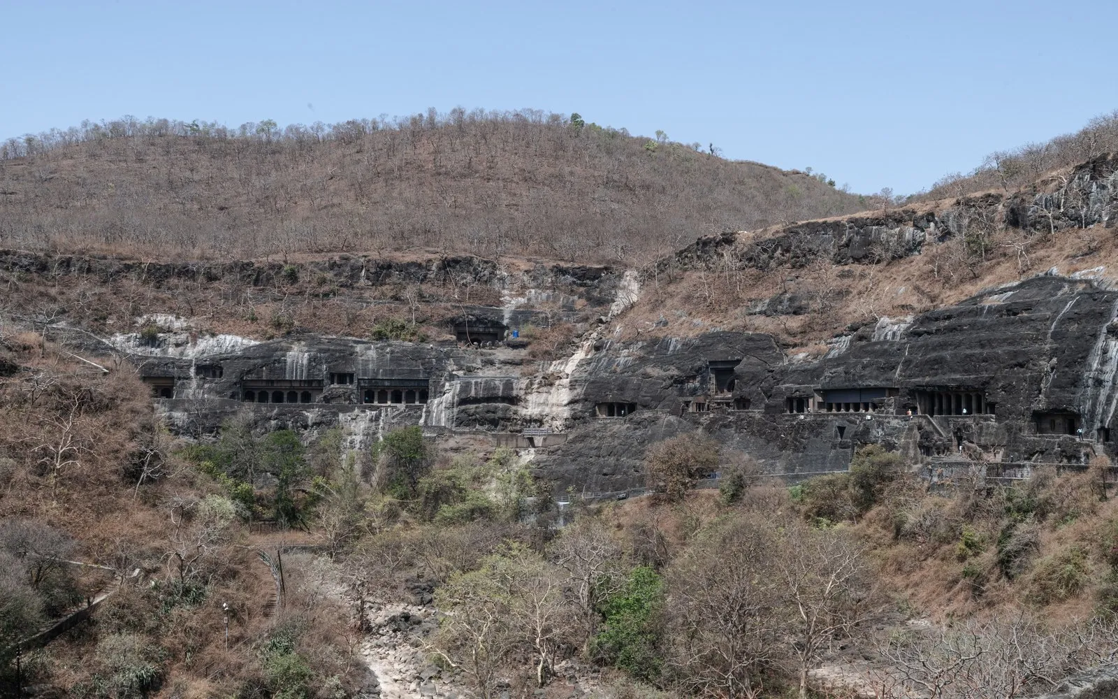 The Ajanta caves cut along the horseshoe bend of the gorge