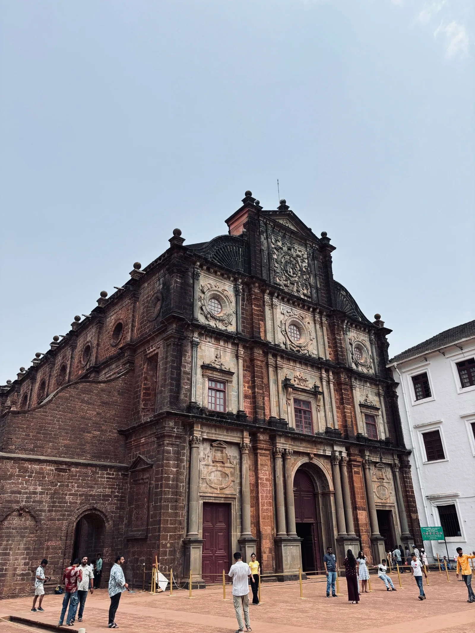 Visitors outside the Basilica of Bom Jesus, Old Goa