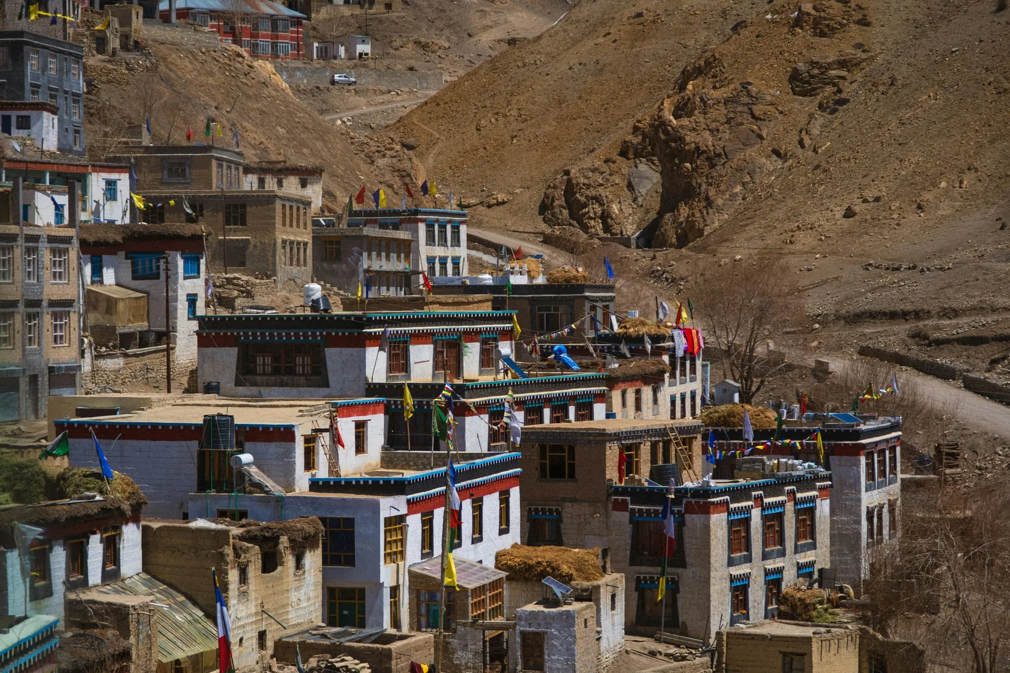 A hillside village of whitewashed houses and prayer flags